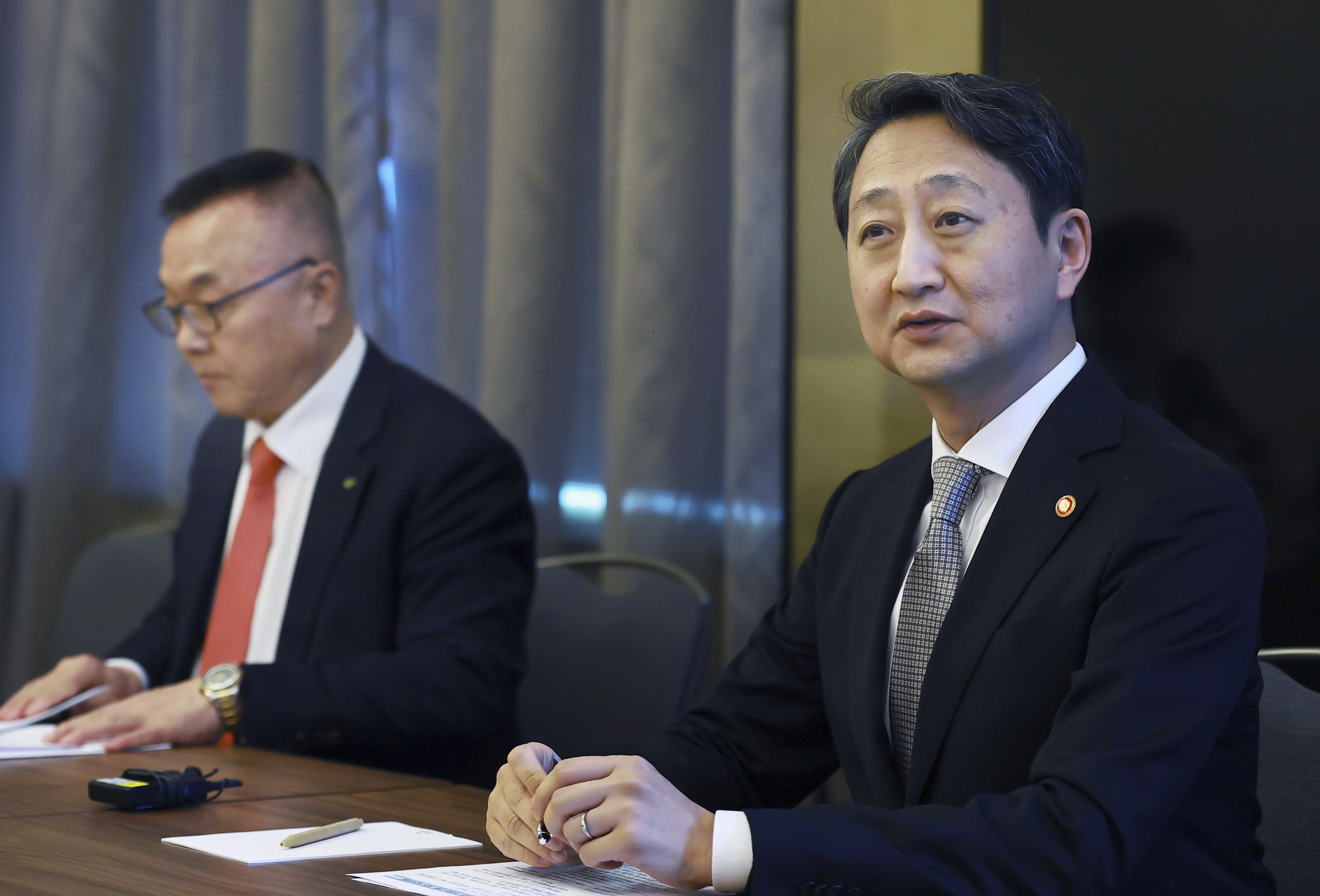 In this photo provided by South Korea's Ministry of Trade, Industry and Energy, South Korean Industry Minister Ahn Duk-geun, right, speaks to reporters in Prague, Czech Republic, Wednesday, May 7, 2025. (South Korea's Ministry of Trade, Industry and Energy via AP)
