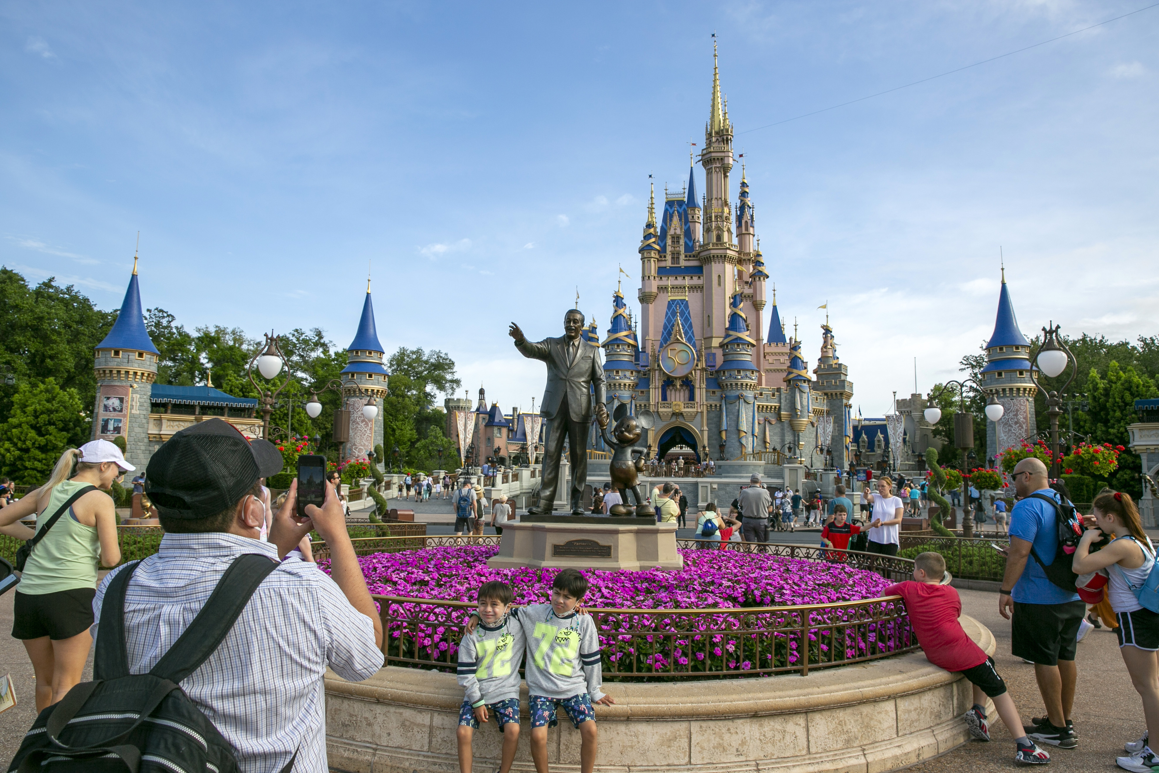 FILE - People visit the Magic Kingdom Park at Walt Disney World Resort in Lake Buena Vista, Fla., April 18, 2022. (AP Photo/Ted Shaffrey, File)