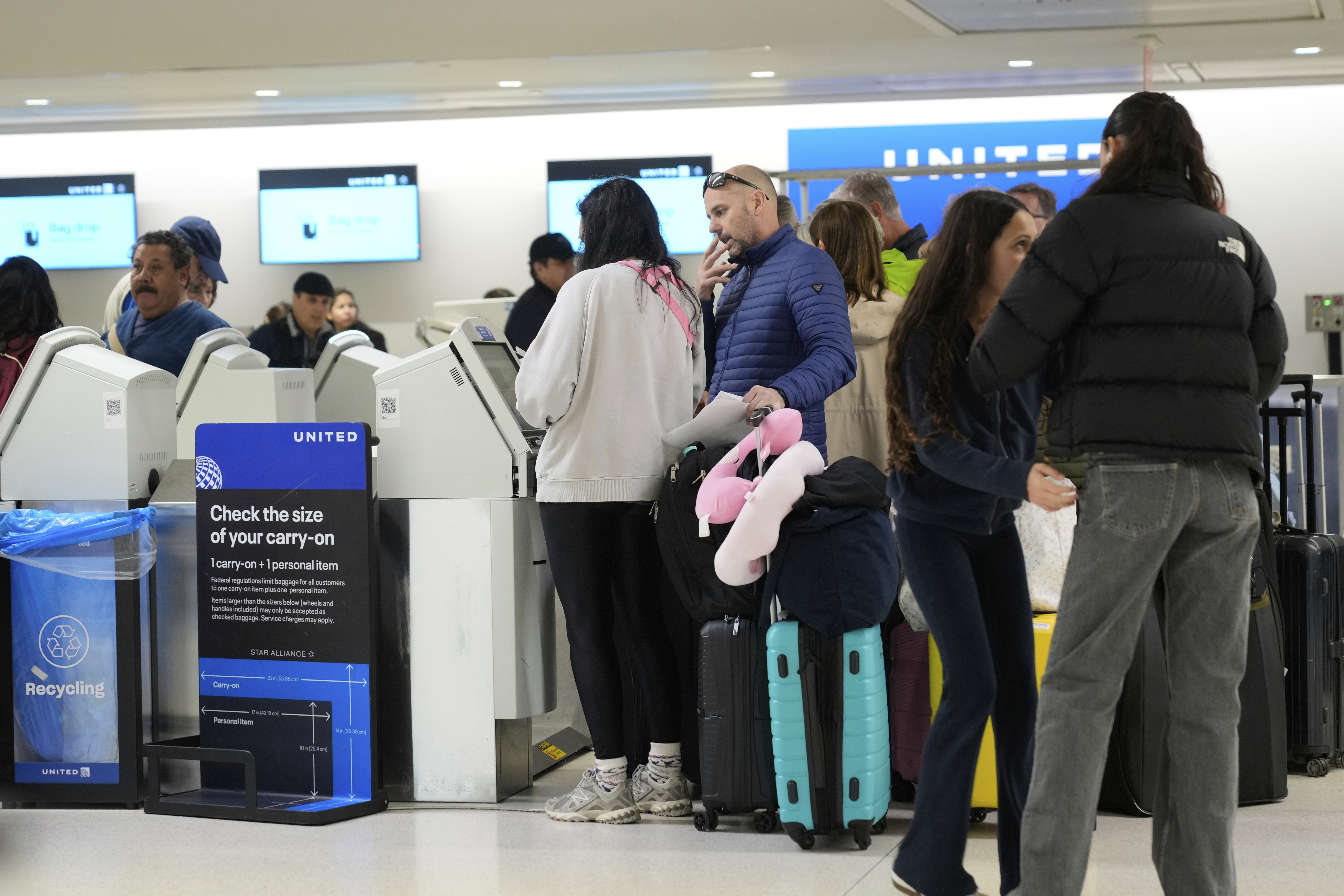 Travelers check into their flights at Newark Liberty International Airport in Newark, N.J., Monday, May 5, 2025. (AP Photo/Seth Wenig)