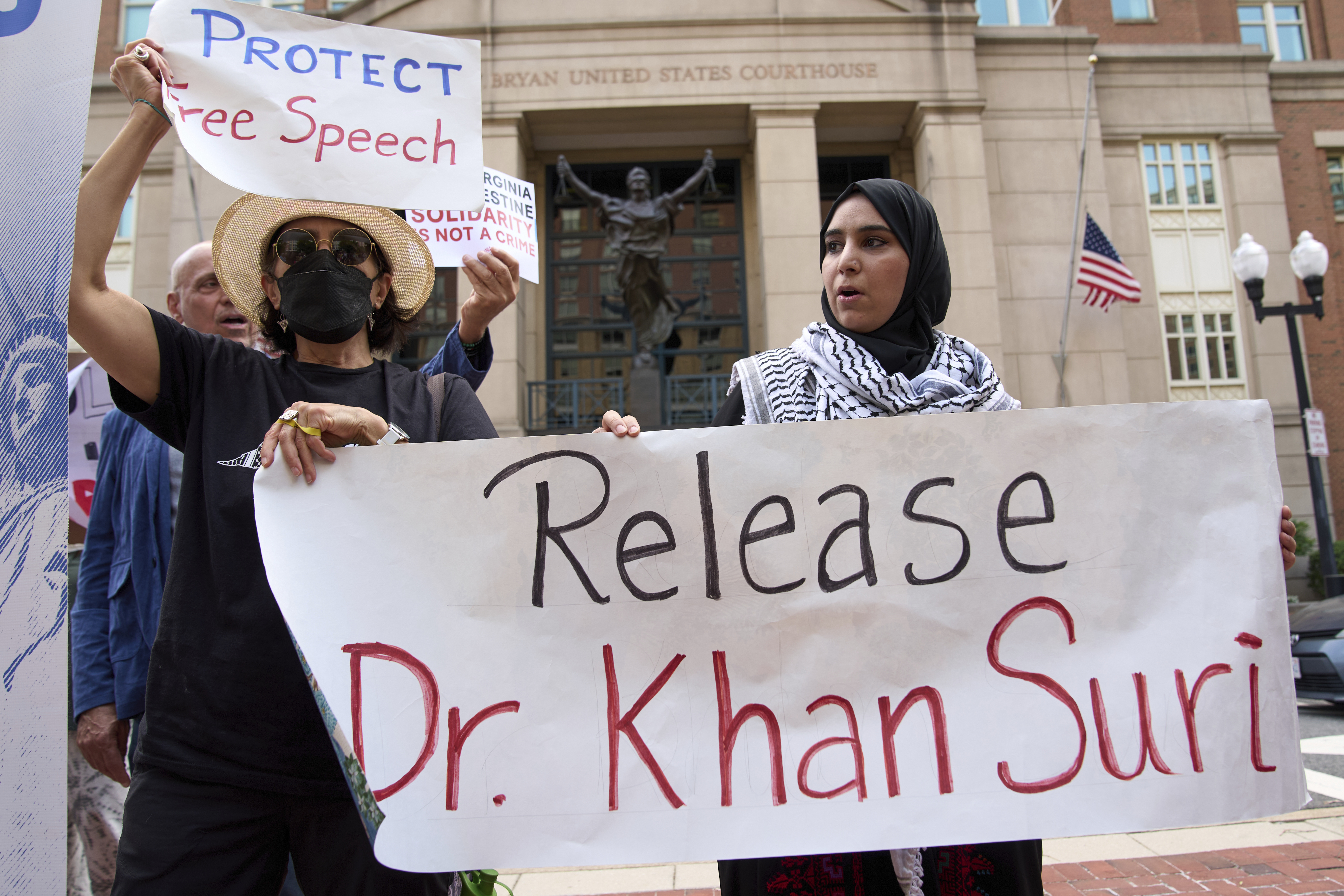 Mapheze Saleh, right, wife of arrested and detained Georgetown University scholar Badar Khan Suri, holds a sign calling for her husband's release after speaking at a news conference following his hearing at Federal District Court for the Eastern District of Virginia, in Alexandria, Va., Thursday, May 1, 2025. (AP Photo/Jacquelyn Martin)