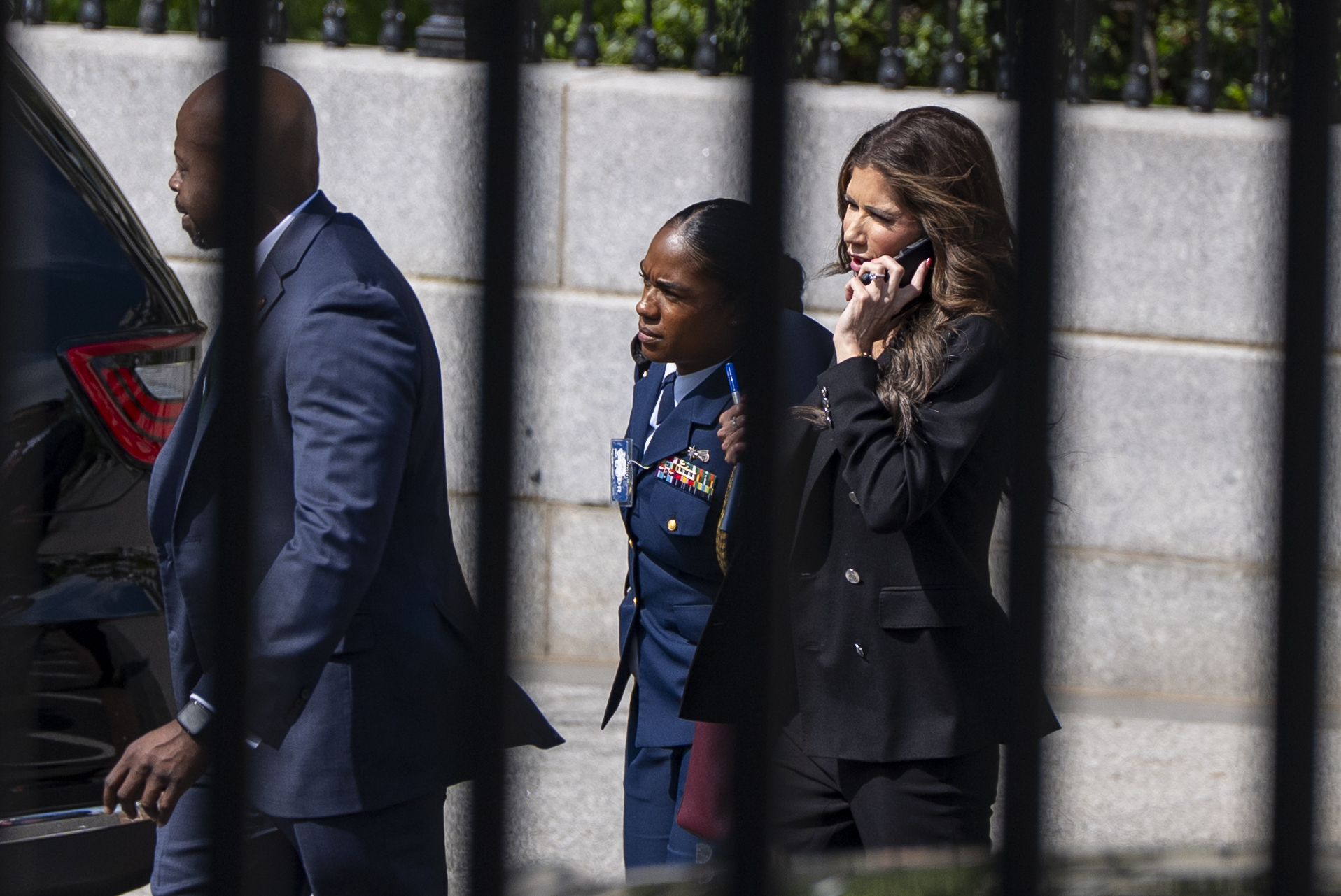 Homeland Security Secretary Kristi Noem, right, walks to the White House, Wednesday, April 30, 2025, in Washington. (AP Photo/Alex Brandon)
