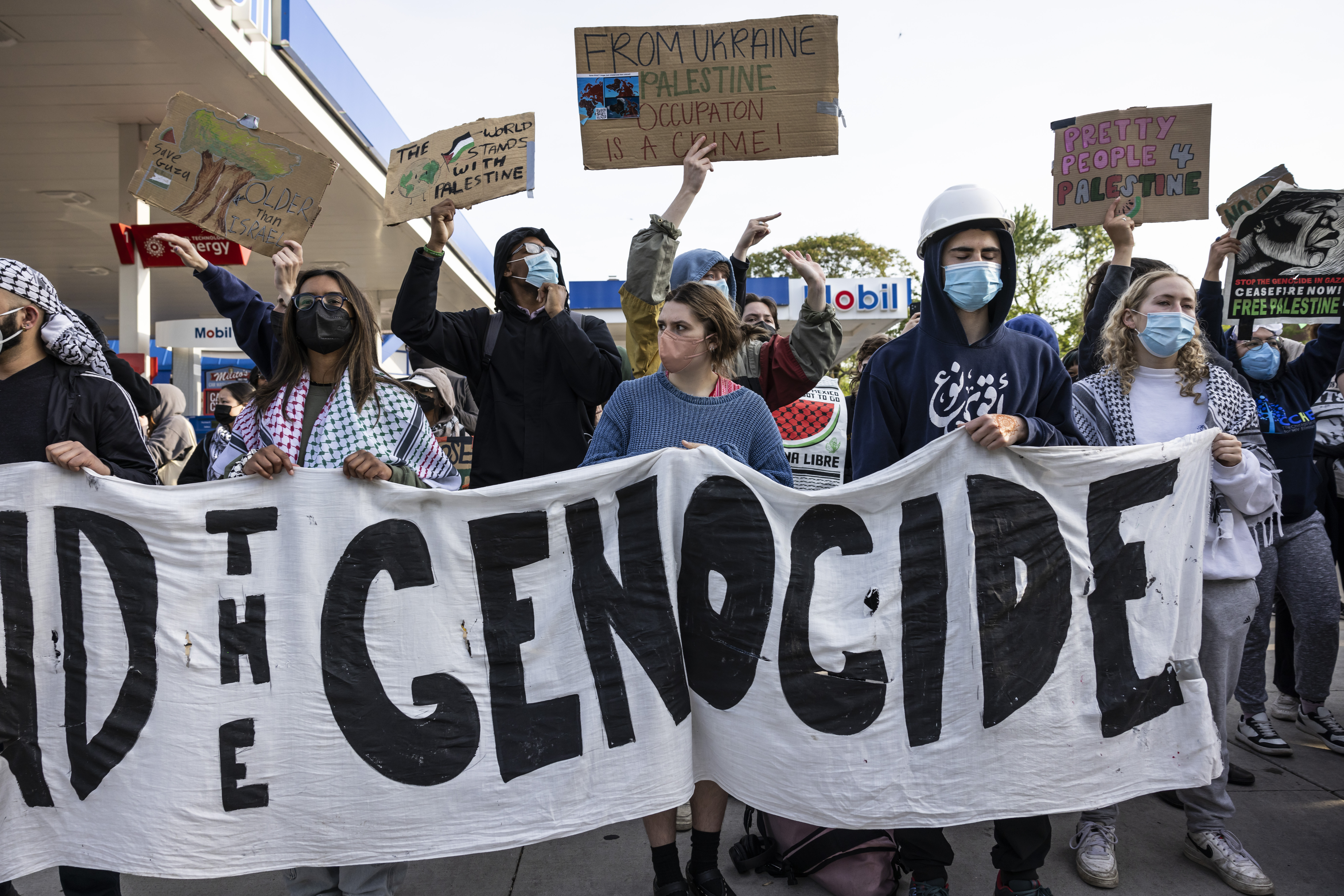 FILE - Chicago police officers keep watch as protesters rally on Fullerton Avenue while crews disassemble the pro-Palestinian encampment in the quad at DePaul University's Lincoln Park campus in Chicago, May 16, 2024. (Ashlee Rezin/Chicago Sun-Times via AP, file)