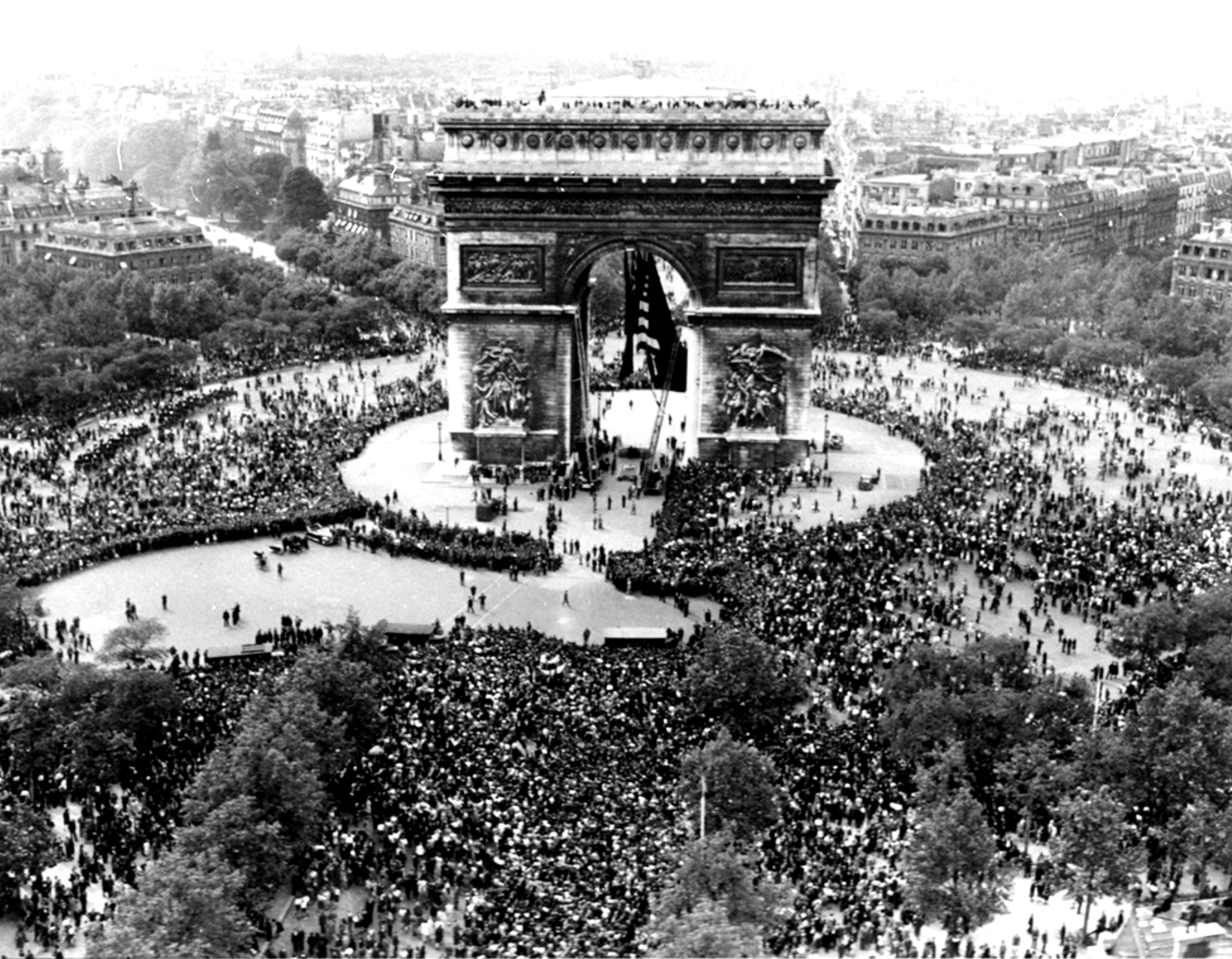 FILE - Thousands celebrate the announcement of Germany's unconditional surrender to the Allies in World War II, on May 7, 1945, at the Arc de Triomphe in Paris on VE Day. (AP Photo/File)