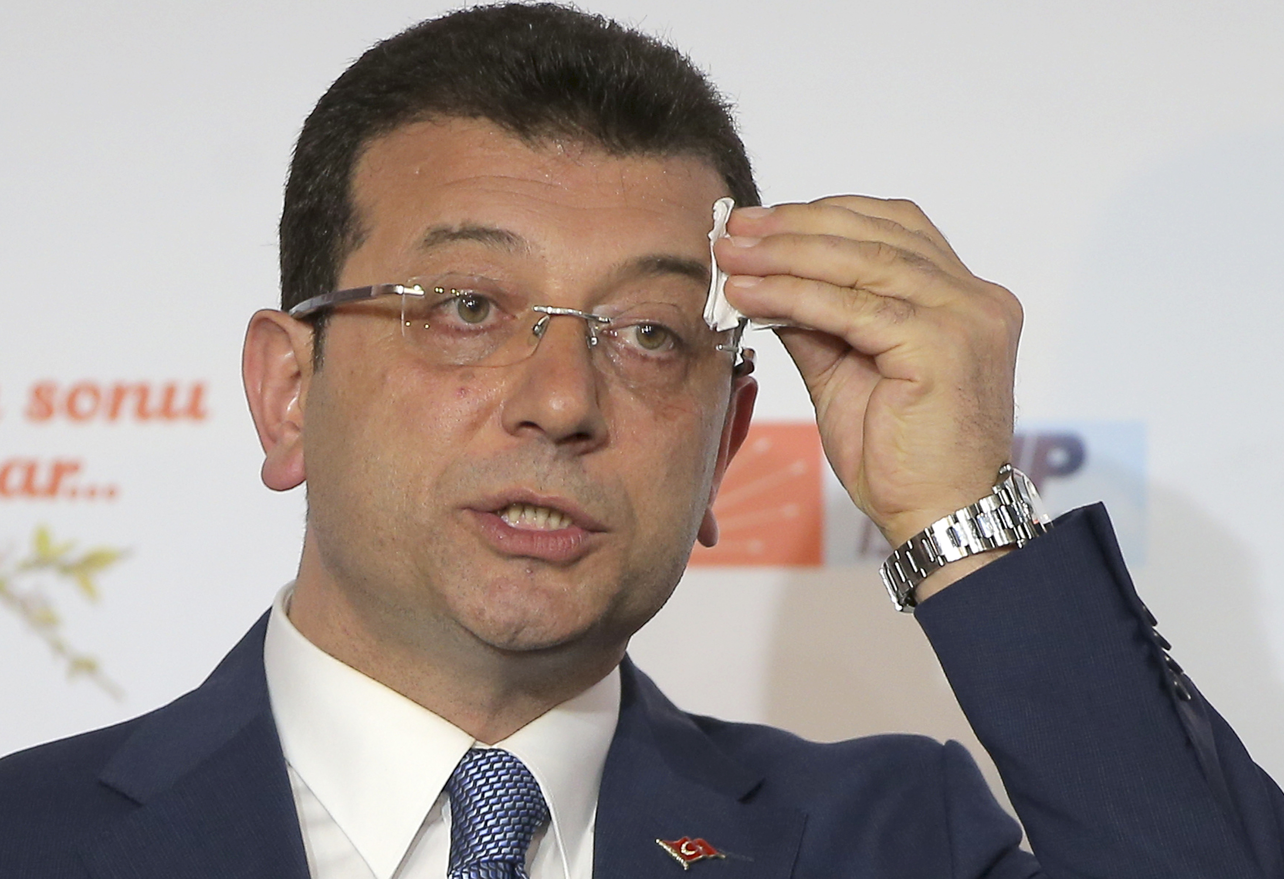FILE -Ekrem Imamoglu, mayoral candidate for Istanbul of Republican People's Party (CHP) wipes sweat off his forehead during a press conference after the local elections, in Istanbul, March 31, 2019. (AP Photo/File)