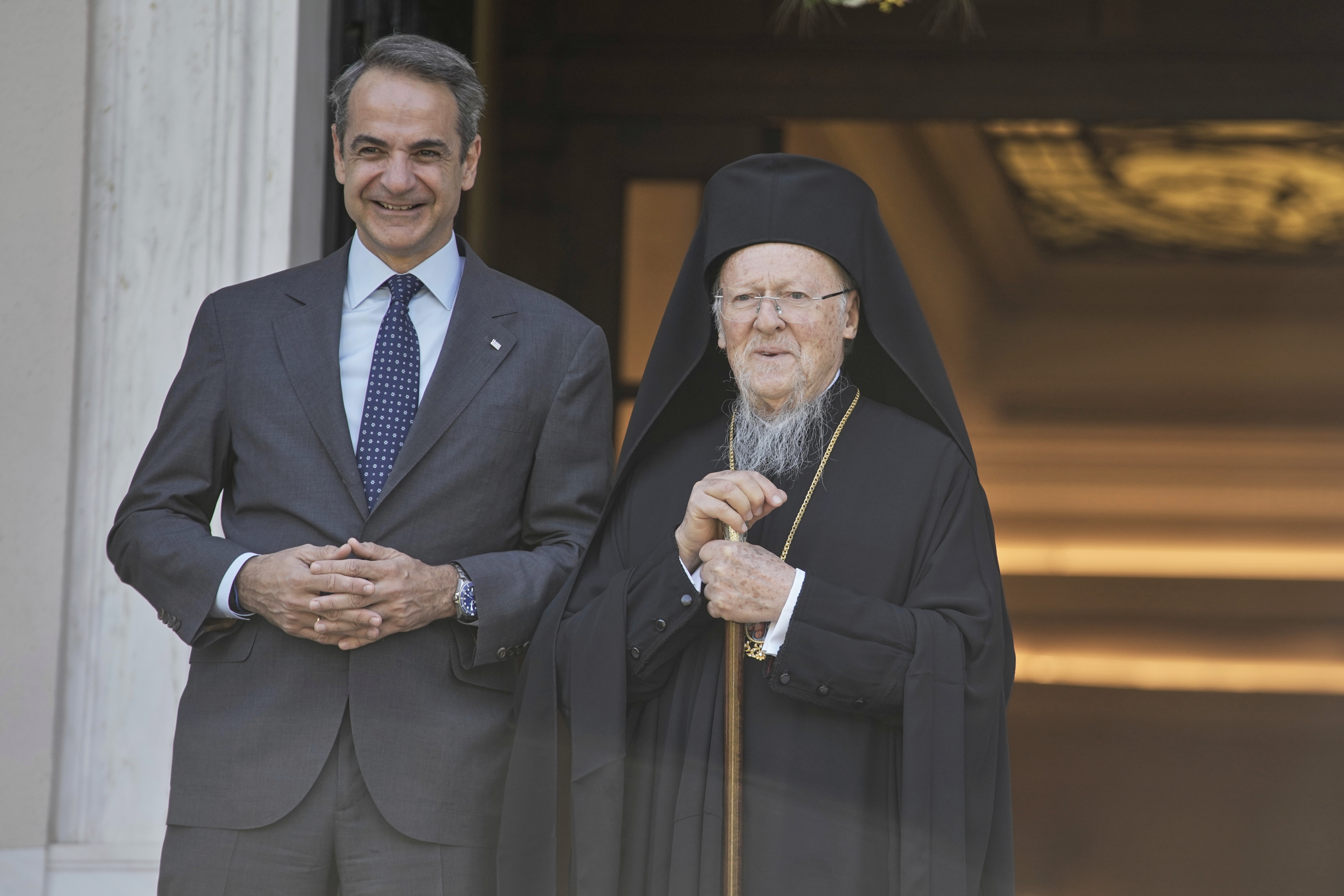 Greece's Prime Minister Kyriakos Mitsotakis, left, and the Orthodox Ecumenical Patriarch Bartholomew pose for photographers before their meeting in Athens, on Thursday May 8, 2025. (AP Photo/Petros Giannakouris)
