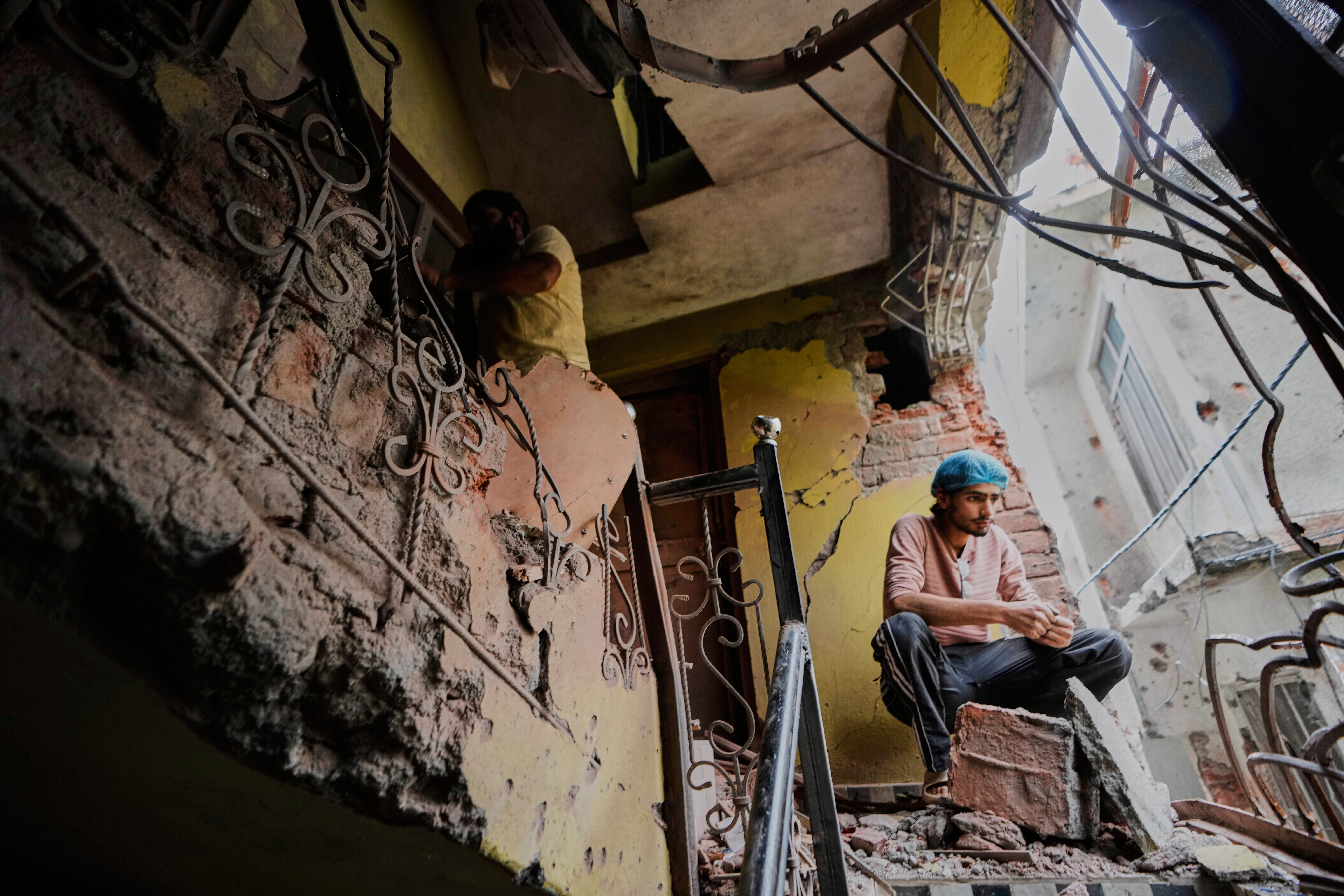 A person sits in his house damaged by Pakistani artillery shelling in Poonch, along the Line of Control, Indian controlled Kashmir, Thursday, May 8, 2025. (AP Photo/Channi Anand)