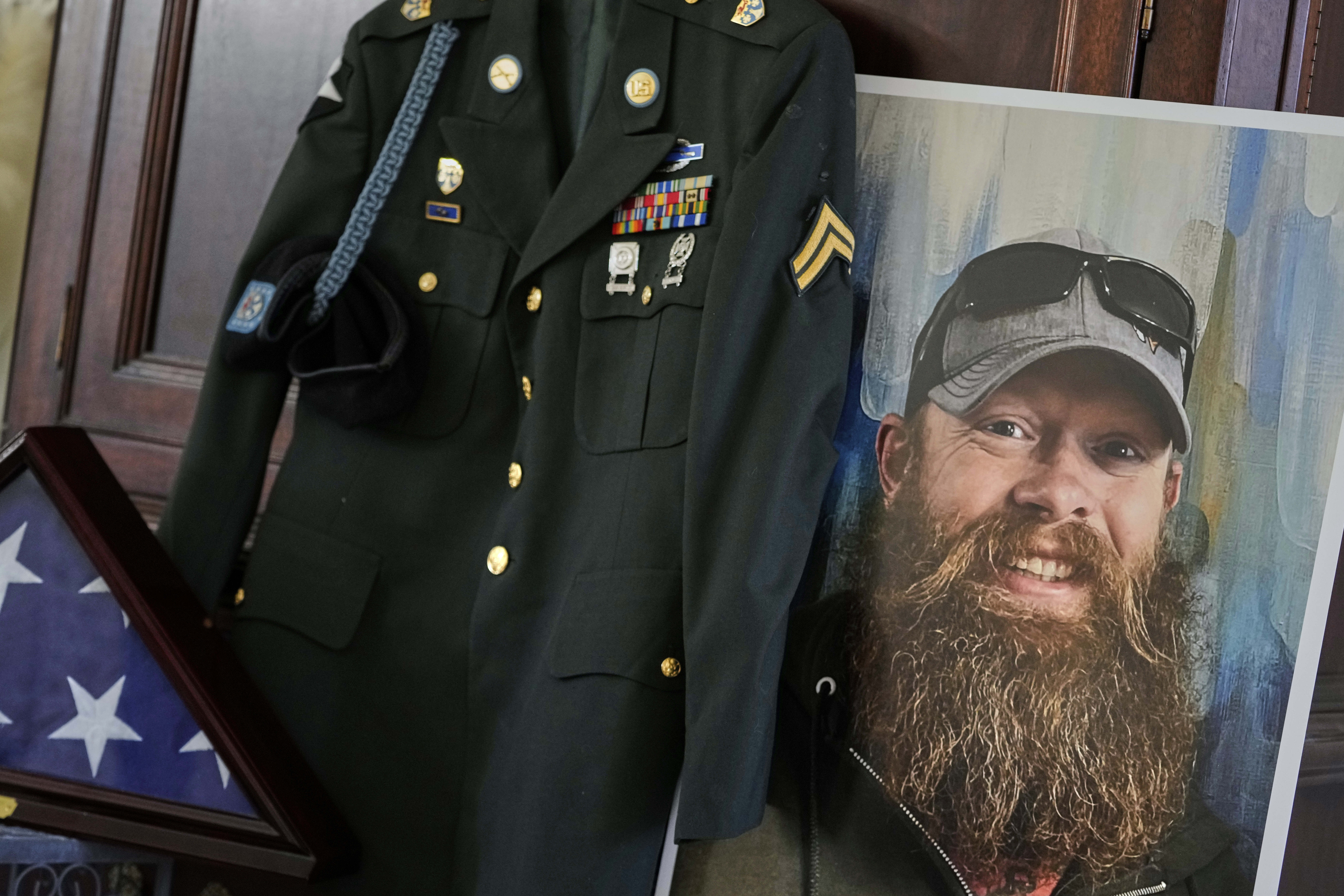 The Army dress uniform and photo of the late Christopher Pelkey is shown at his mother's home, Wednesday, May 7, 2025, in Chandler, Ariz. (AP Photo/Matt York)