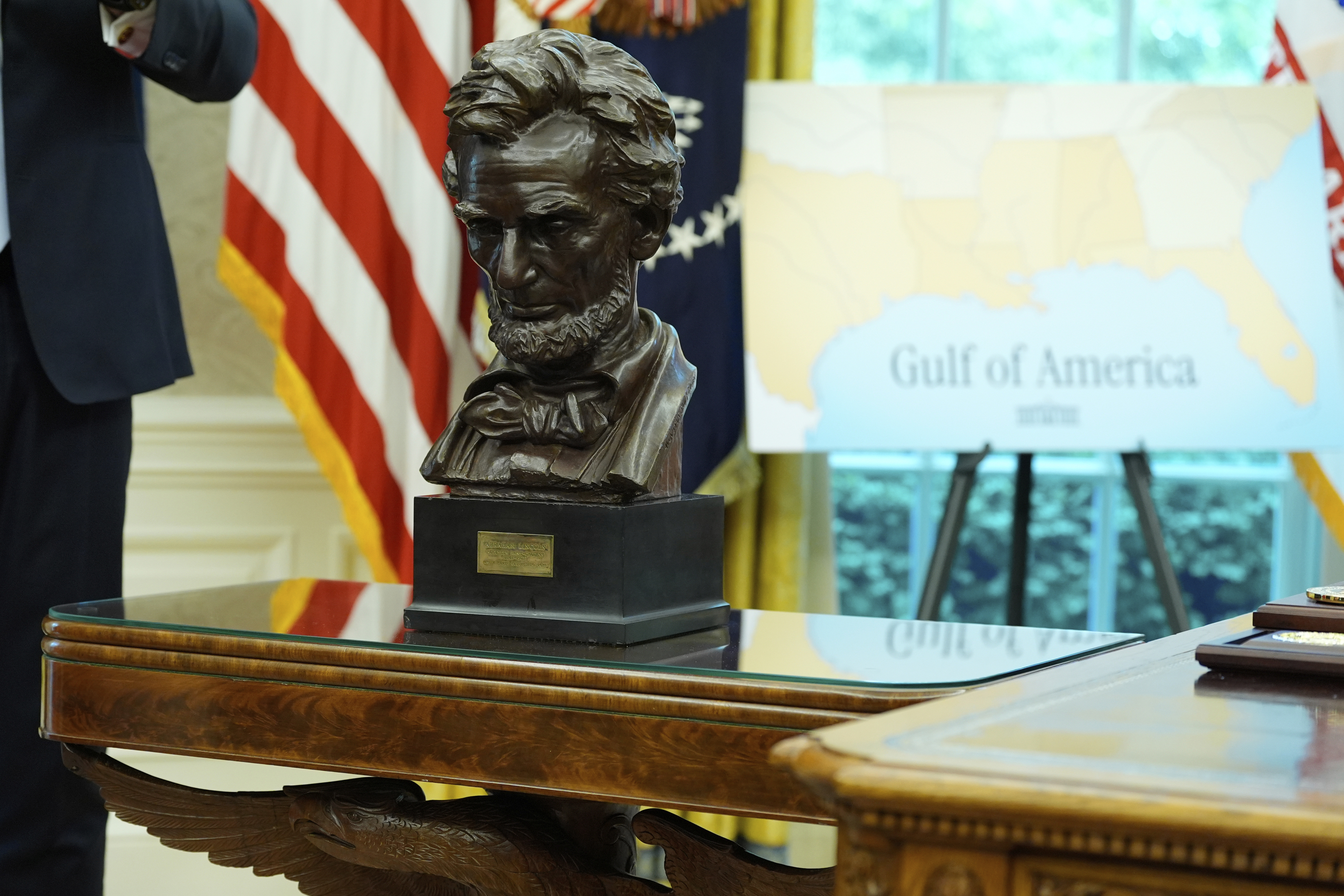 A bust of Abraham Lincoln and a map showing "Gulf of America" written on it is pictured in the Oval Office of the White House as President Donald Trump speaks during an event to announce that the 2027 NFL Draft will be held on the National Mall, Monday, May 5, 2025, in Washington. (AP Photo/Alex Brandon)