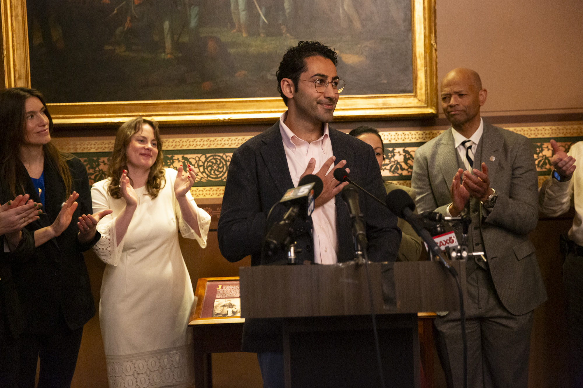 Mohsen Mahdawi, center, speaks during a press conference announcing the launch of the Vermont Immigration Legal Defense Fund in the Cedar Creek Reception Room at the Vermont State House on Thursday, May 8, 2025, in Montpelier, Vt. (AP Photo/Alex Driehaus)