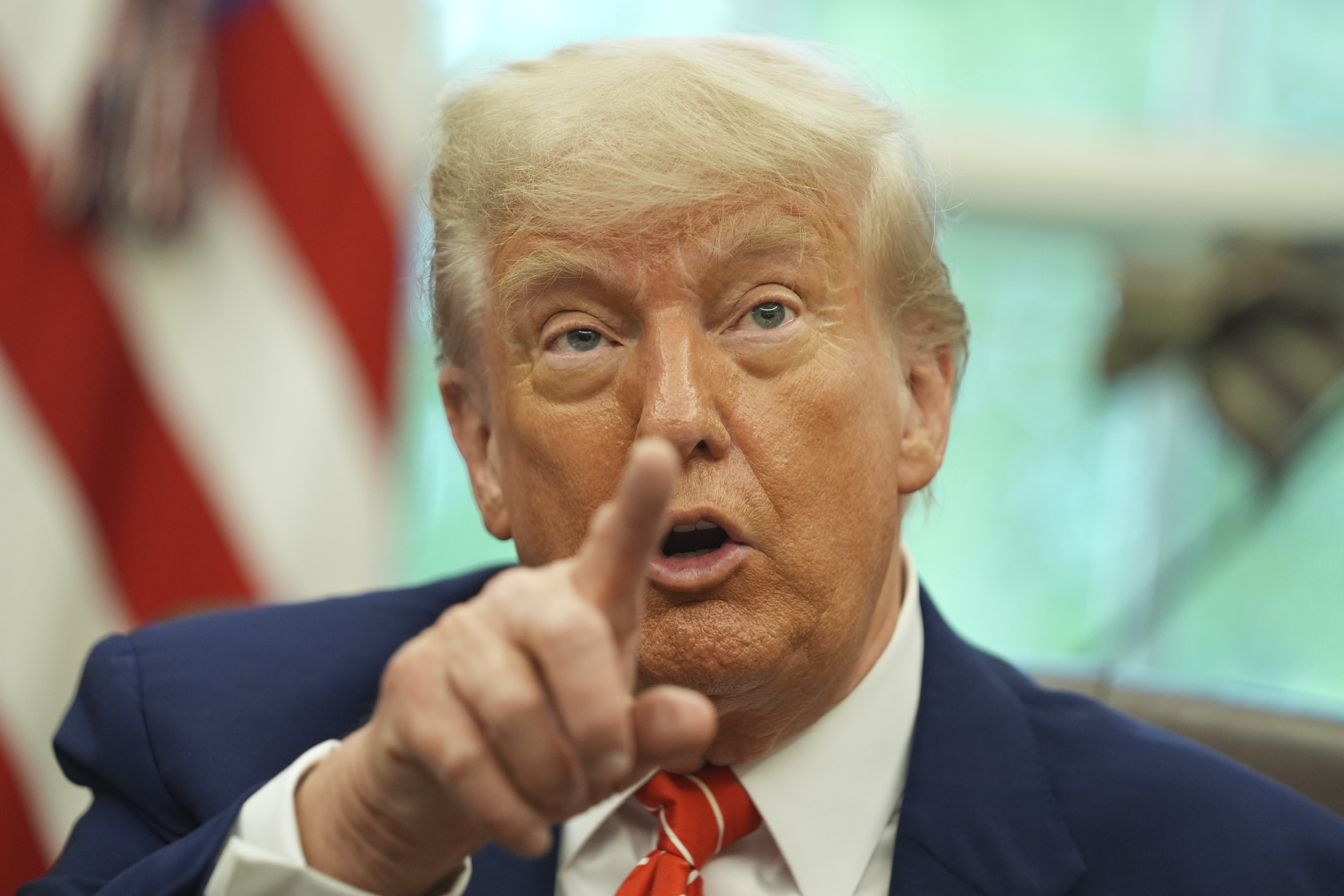 President Donald Trump gestures as he speaks with reporters after announcing a trade deal with United Kingdom in the Oval Office of the White House, Thursday, May 8, 2025, in Washington. (AP Photo/Evan Vucci)