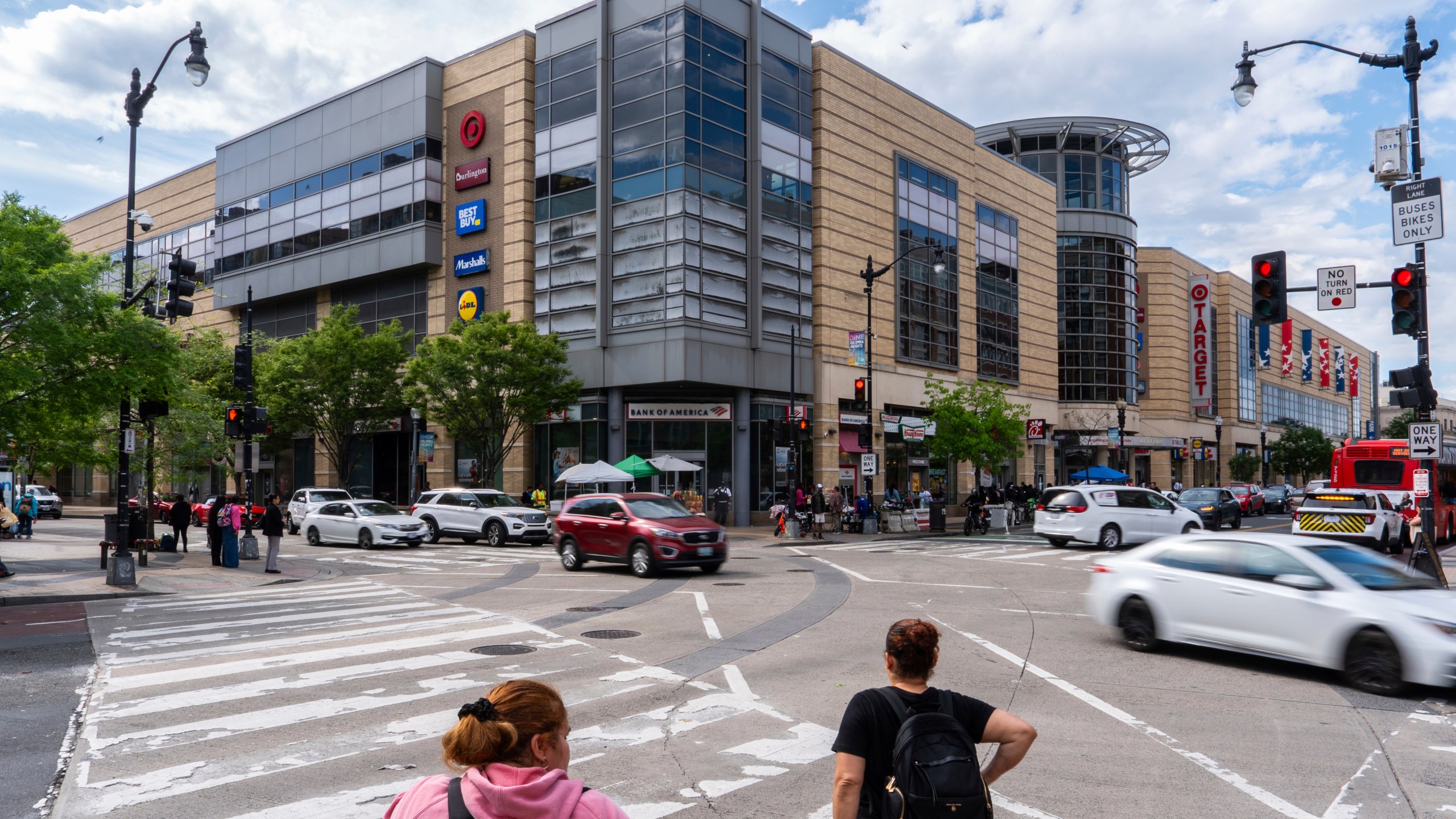 People wait to cross an intersection in front of the Columbia Heights metro station, Tuesday, May 6, 2025, in Washington. (AP Photo/Julia Demaree Nikhinson)