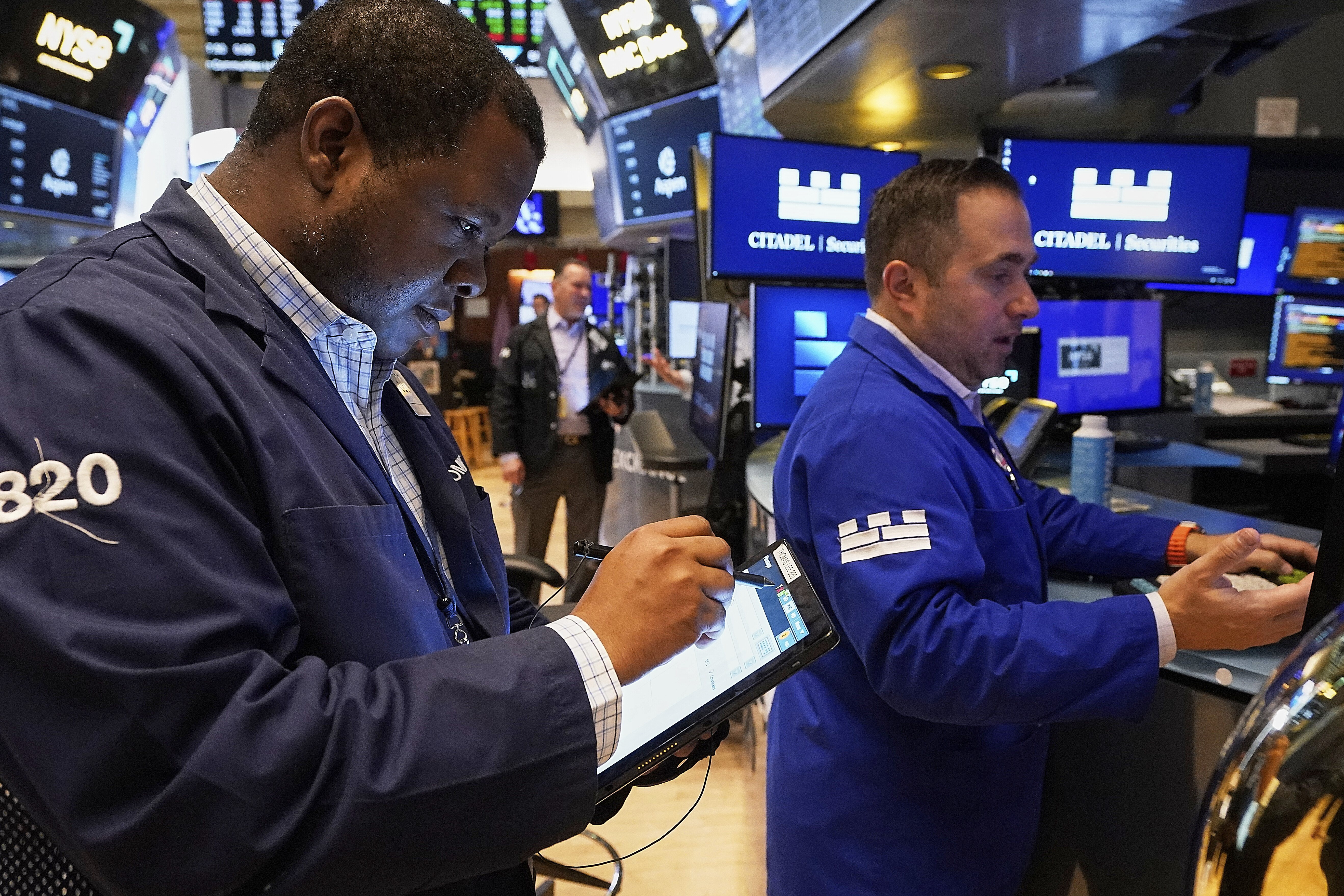 Trader Thomas Lee, left, and specialist Genarro Saporito work on the floor of the New York Stock Exchange, Thursday, May 8, 2025. (AP Photo/Richard Drew)