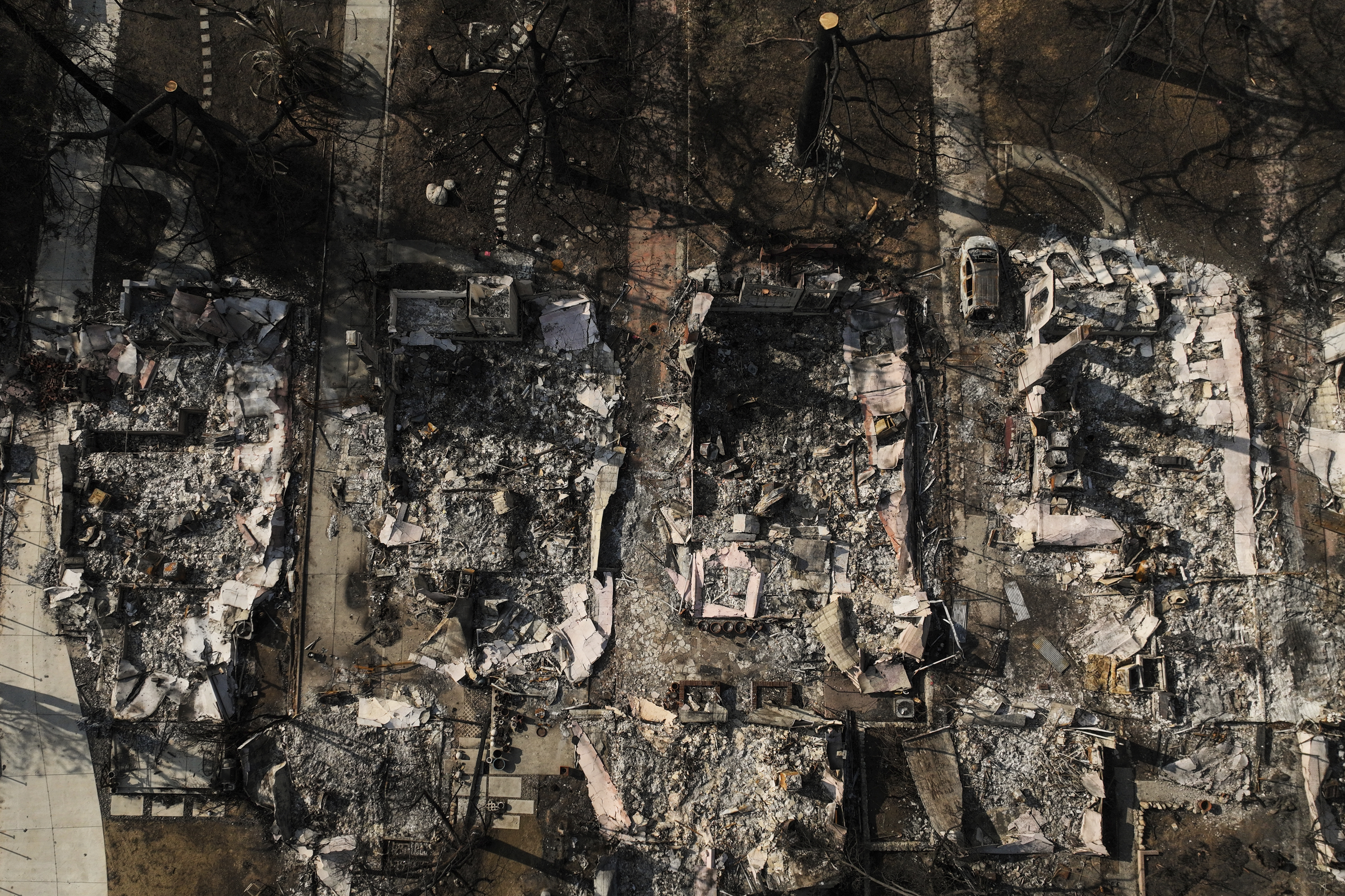 FILE - An aerial photo shows the charred homes of Louise Hamlin, center left, and Chris Wilson, center right, after the Eaton Fire in Altadena, Calif., Thursday, Jan. 30, 2025. (AP Photo/Jae C. Hong, File)