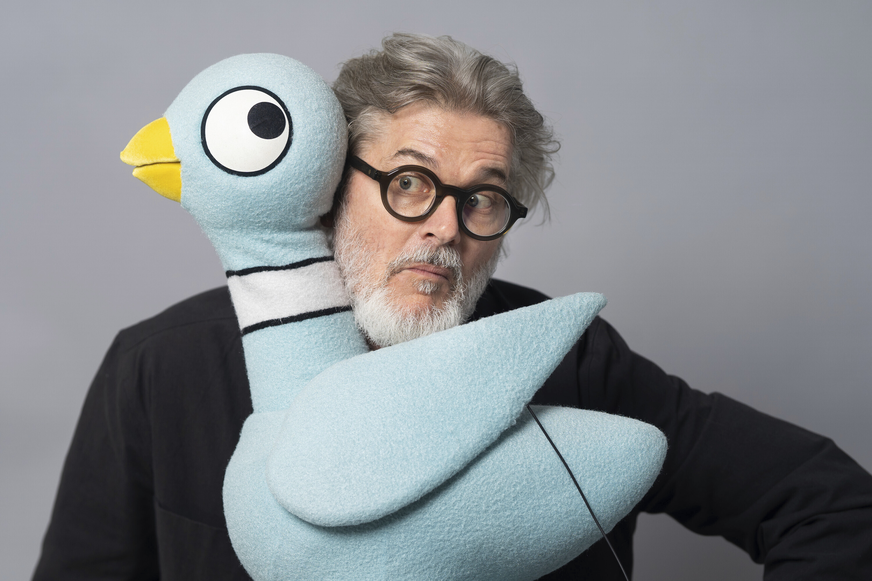 Author Mo Willems poses with The Pigeon, a character in his children's books, on April 22, 2025, in New York. (AP Photo/Gary Gerard Hamilton)