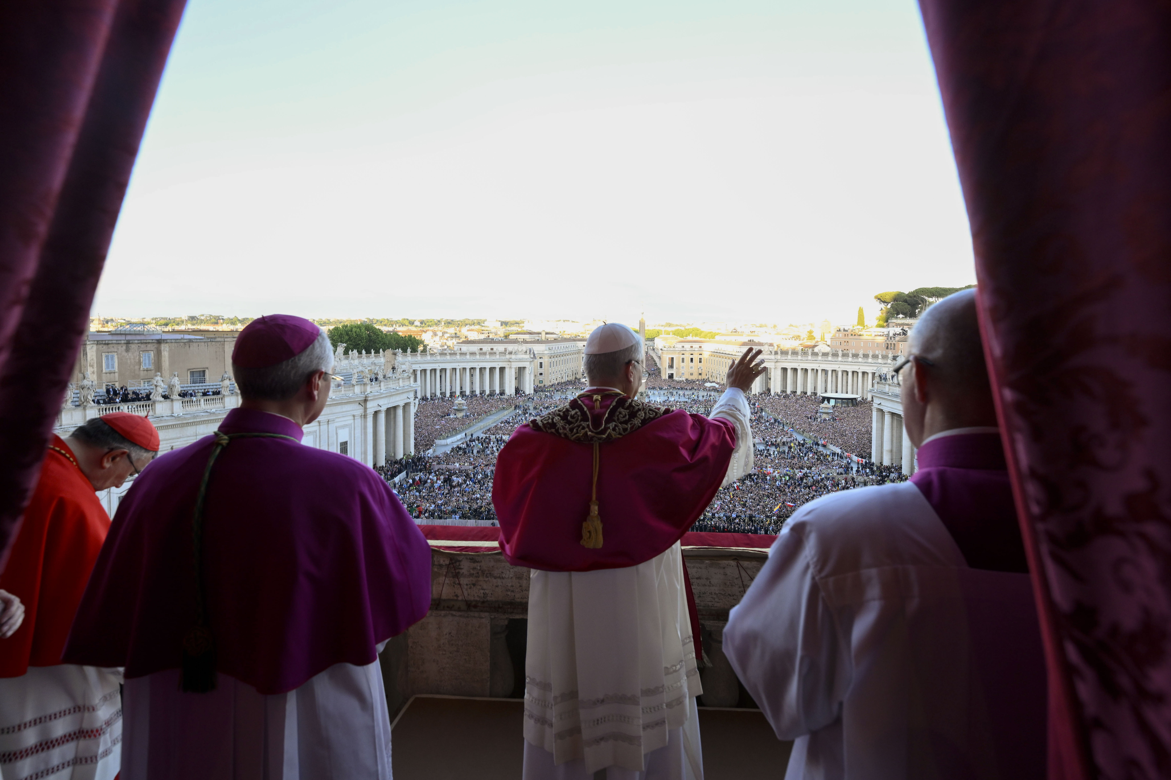 Newly elected Pope Leo XIV waves to faithful and pilgrims gathered in St. Peter's Square at the Vatican shortly after his election, Thursday, May 8, 2025. (Vatican Media via AP)