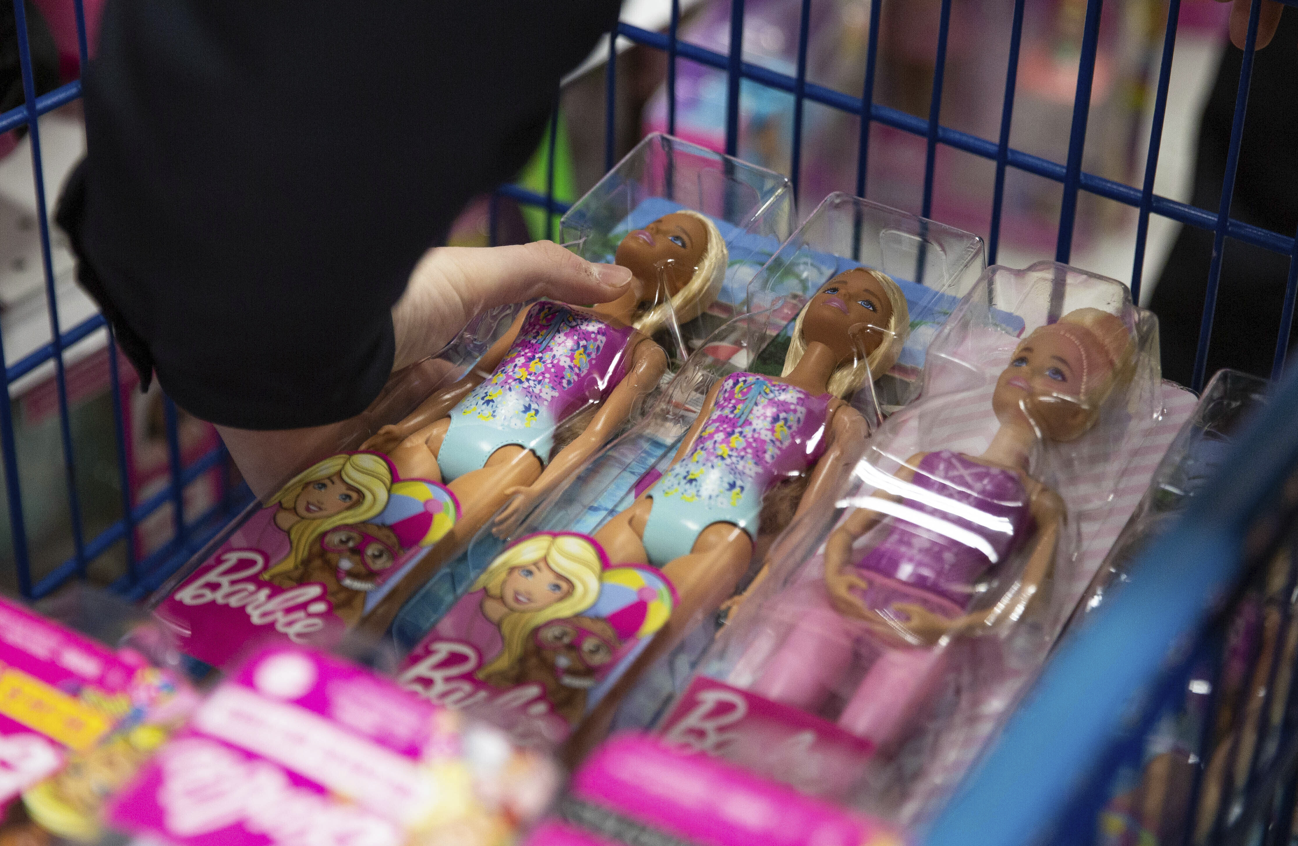 A collection of Barbie dolls are placed into a cart in Bowling Green, Ky., on Tuesday, Dec. 7, 2021. (Grace Ramey/Daily News via AP, File)