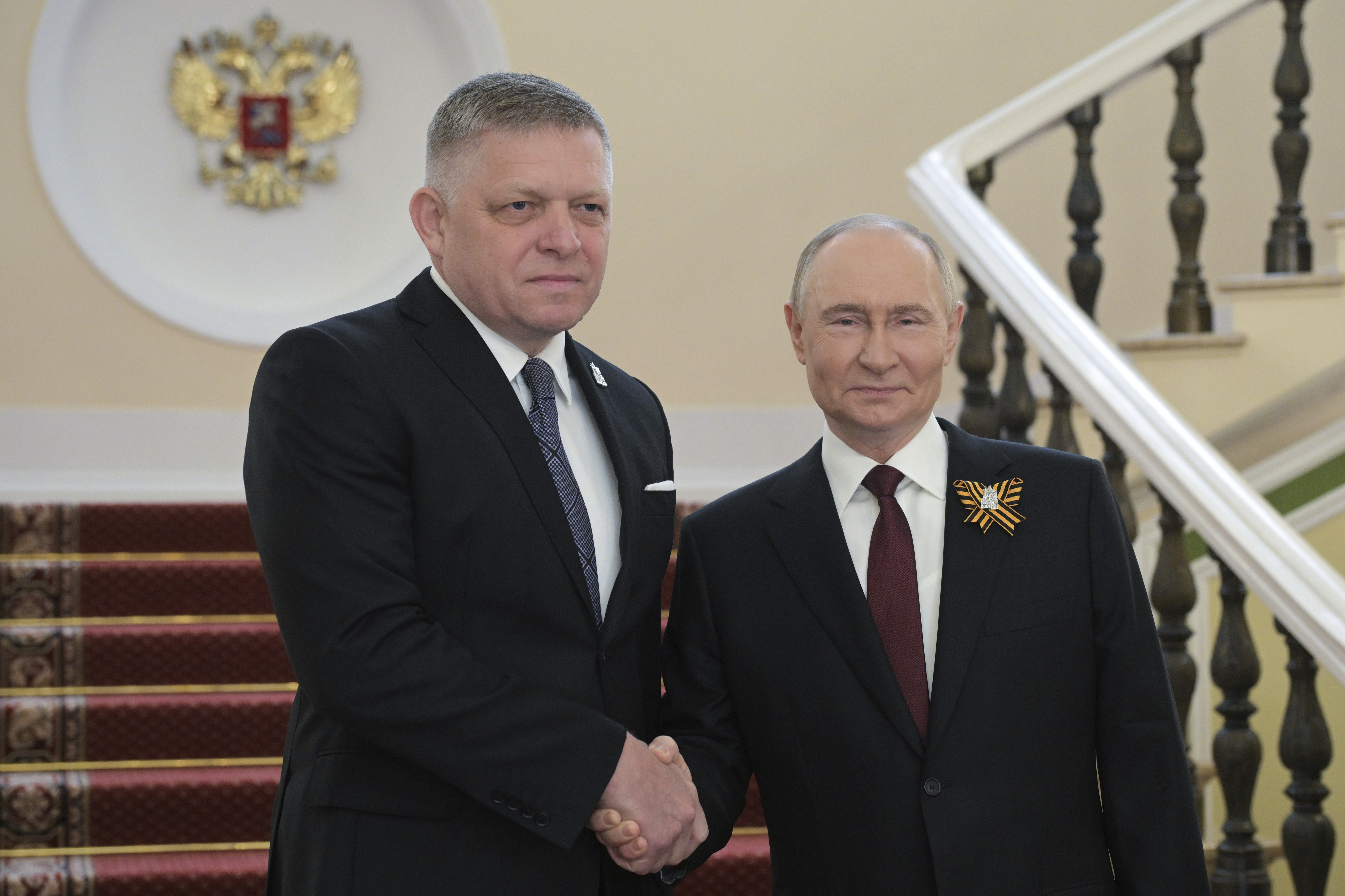 Prime Minister of Slovakia Robert Fico, left, and Russian President Vladimir Putin shake hands during their meeting before the Victory Day military parade in Moscow, Russia, Friday, May 9, 2025, during celebrations of the 80th anniversary of the Soviet Union's victory over Nazi Germany during the World War II. (Alexei Nikolsky/Photo host agency RIA Novosti via AP)