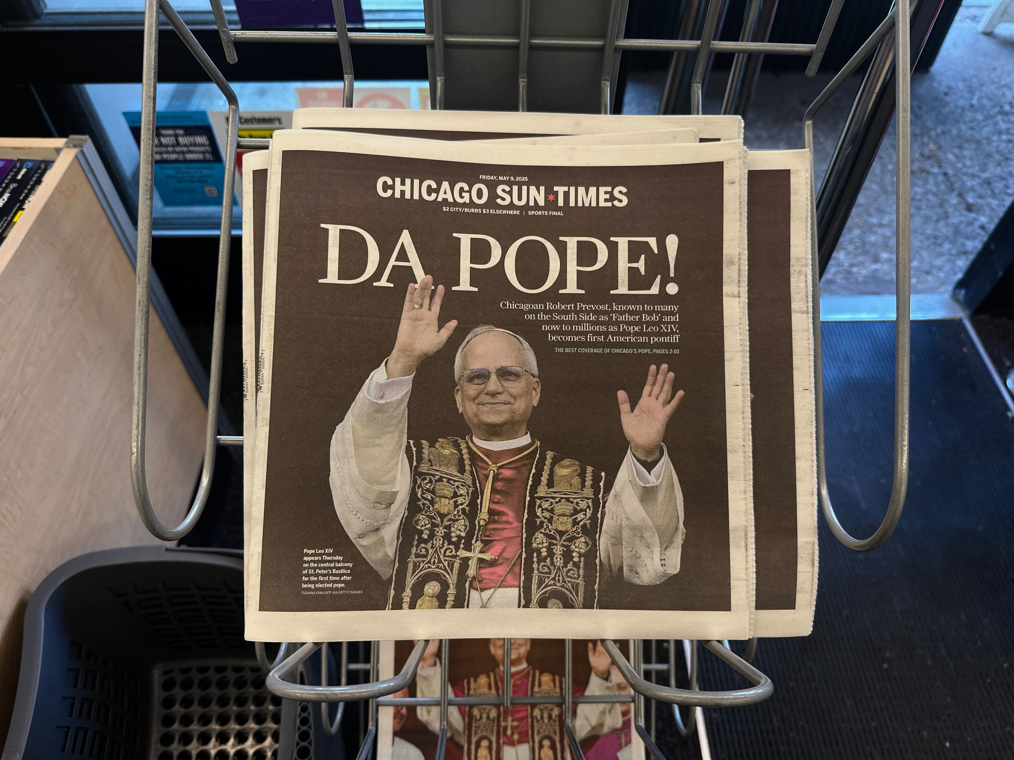 Chicago Sun Times newspaper front page showing Pope Leo XIV is seen on a newspaper rack at a store, Friday, May 9, 2025, in Chicago. (AP Photo/Melina Walling)