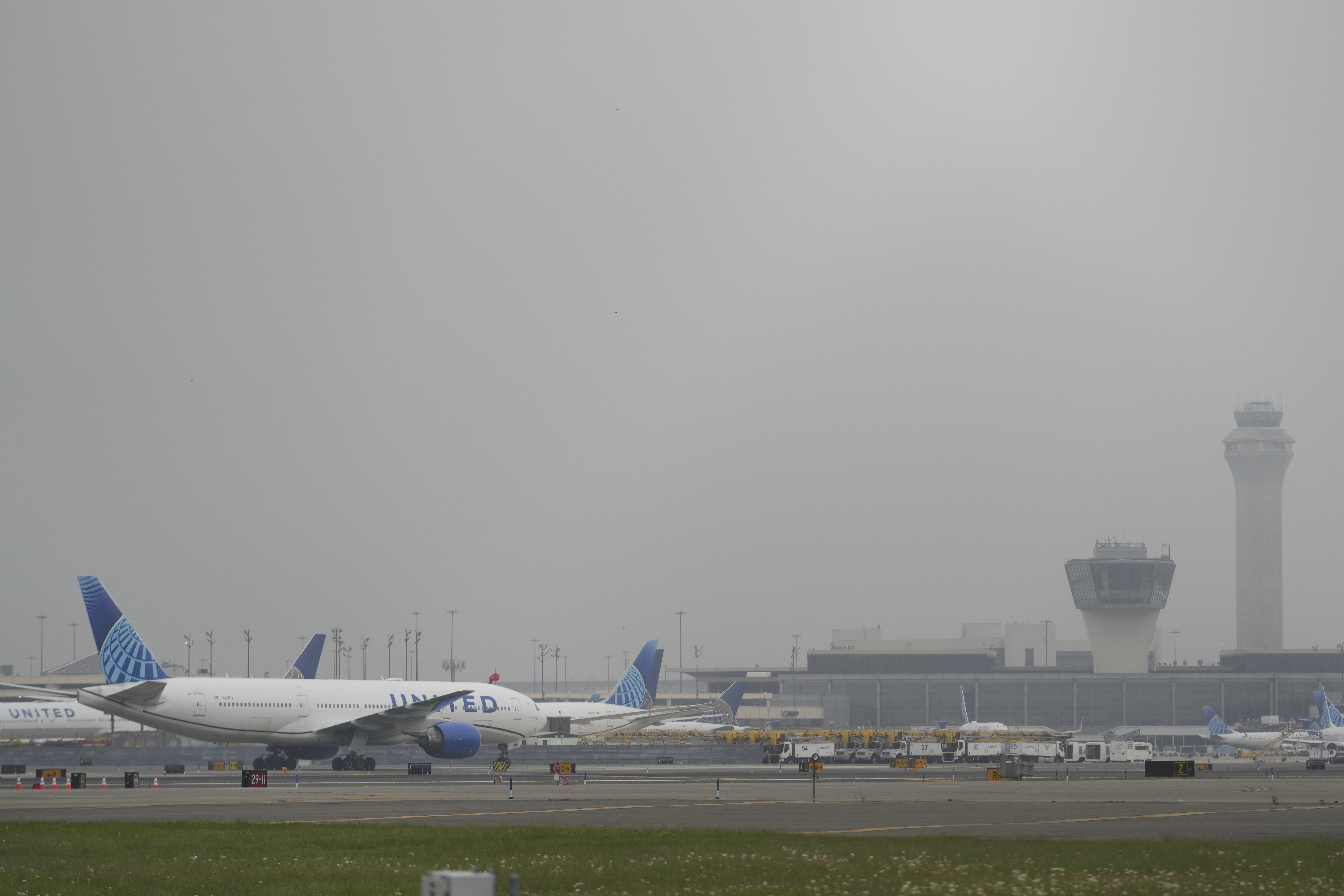 Fog covers planes and control towers at Newark Liberty International Airport in Newark, N.J., Monday, May 5, 2025. (AP Photo/Seth Wenig)