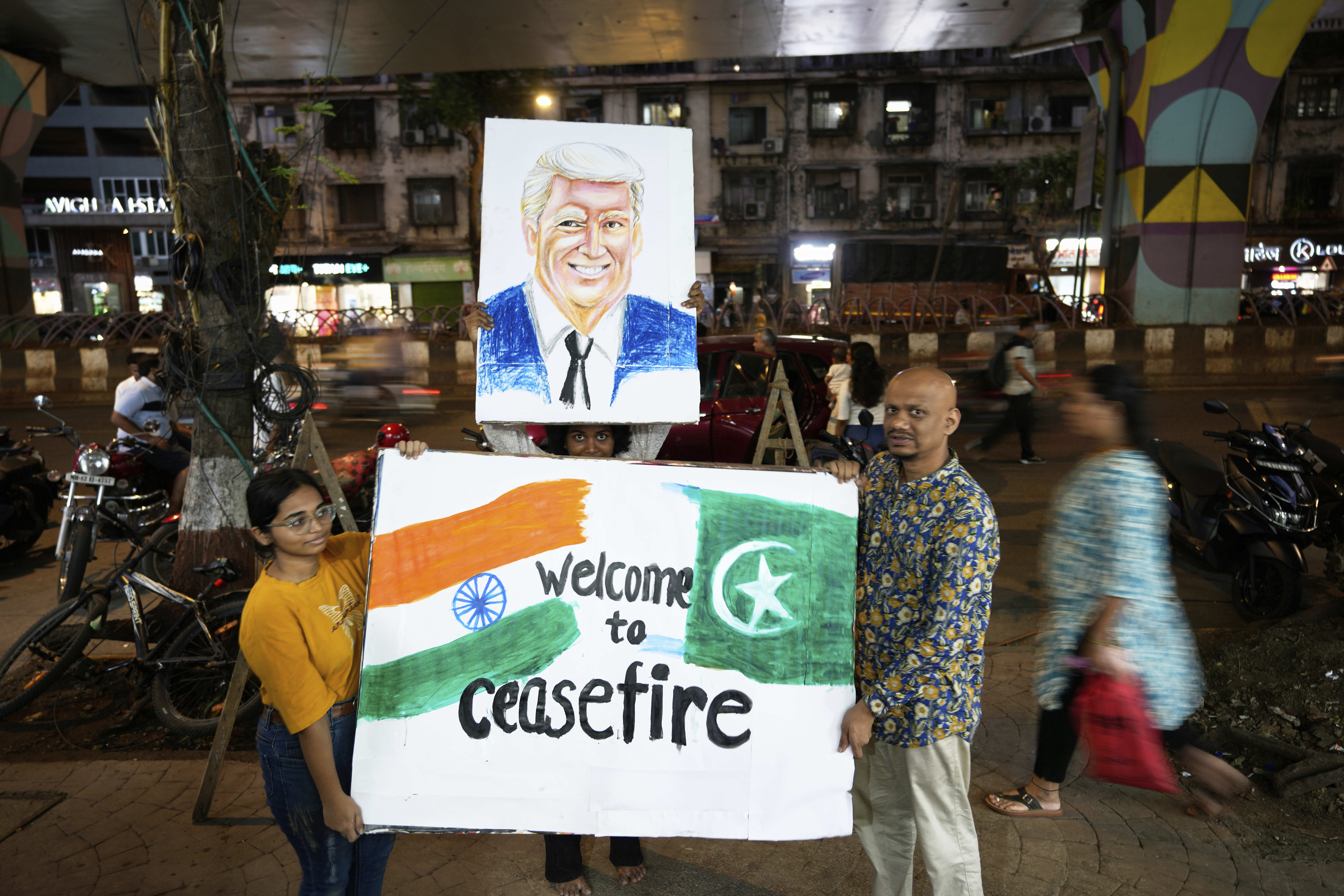 Students of an art school and their teacher carry a hand-drawn portrait of the US President Donald Trump as they celebrate the ceasefire between India and Pakistan, in Mumbai, India, Saturday, May 10, 2025. (AP Photo/Rajanish Kakade)
