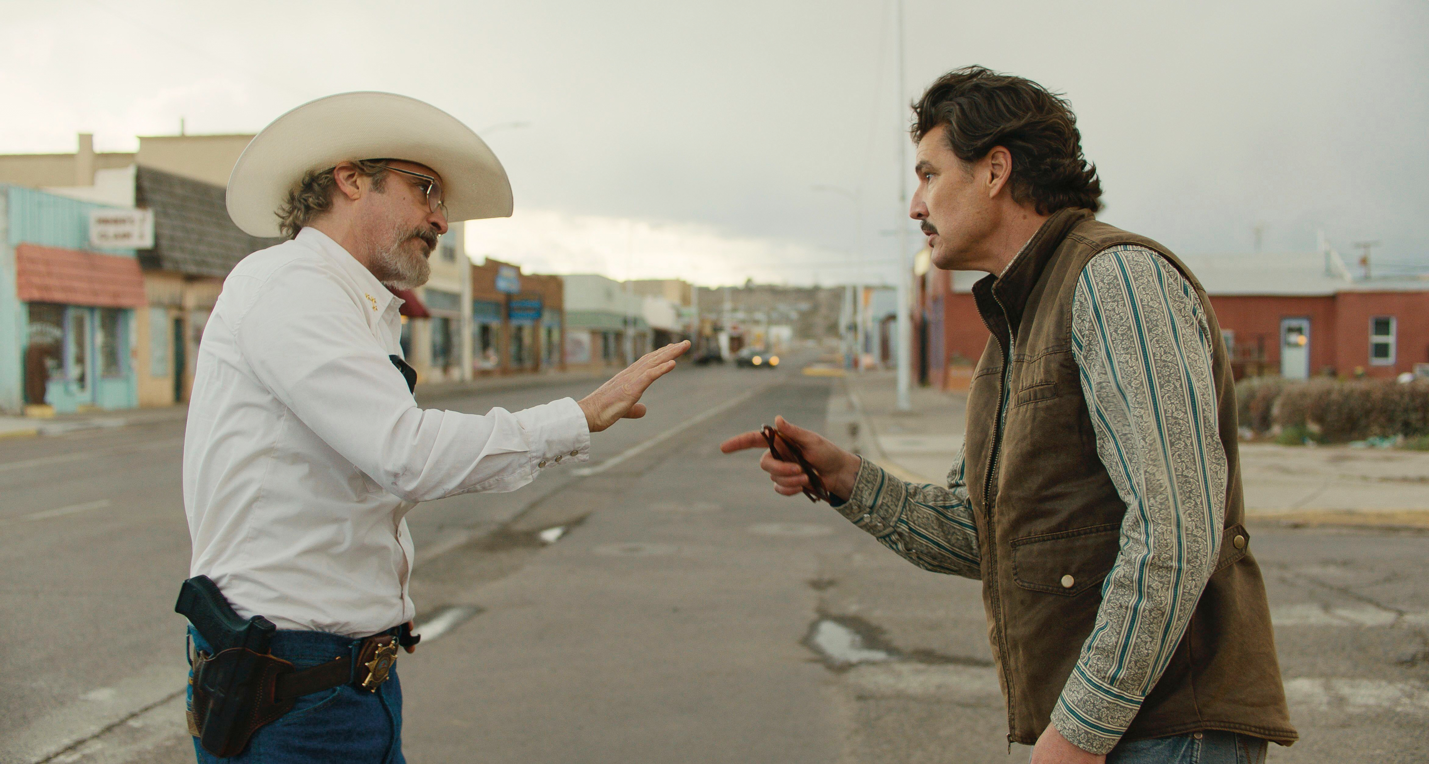 This image released by A24 shows Joaquin Phoenix, left, and Pedro Pascal in a scene from "Eddington." (A24 via AP)