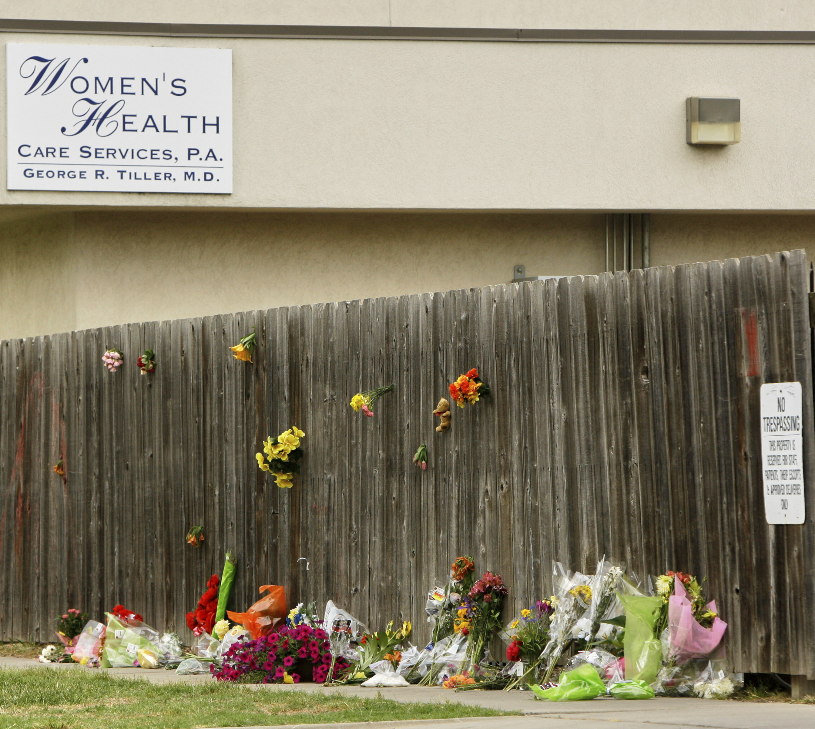 FILE - Mementos are placed at a memorial outside Women's Health Care Services owned by Dr. George Tiller in Wichita, Kan., Tuesday, June 2, 2009, after he was fatally shot during church services Sunday. (AP Photo/Charlie Riedel, File)