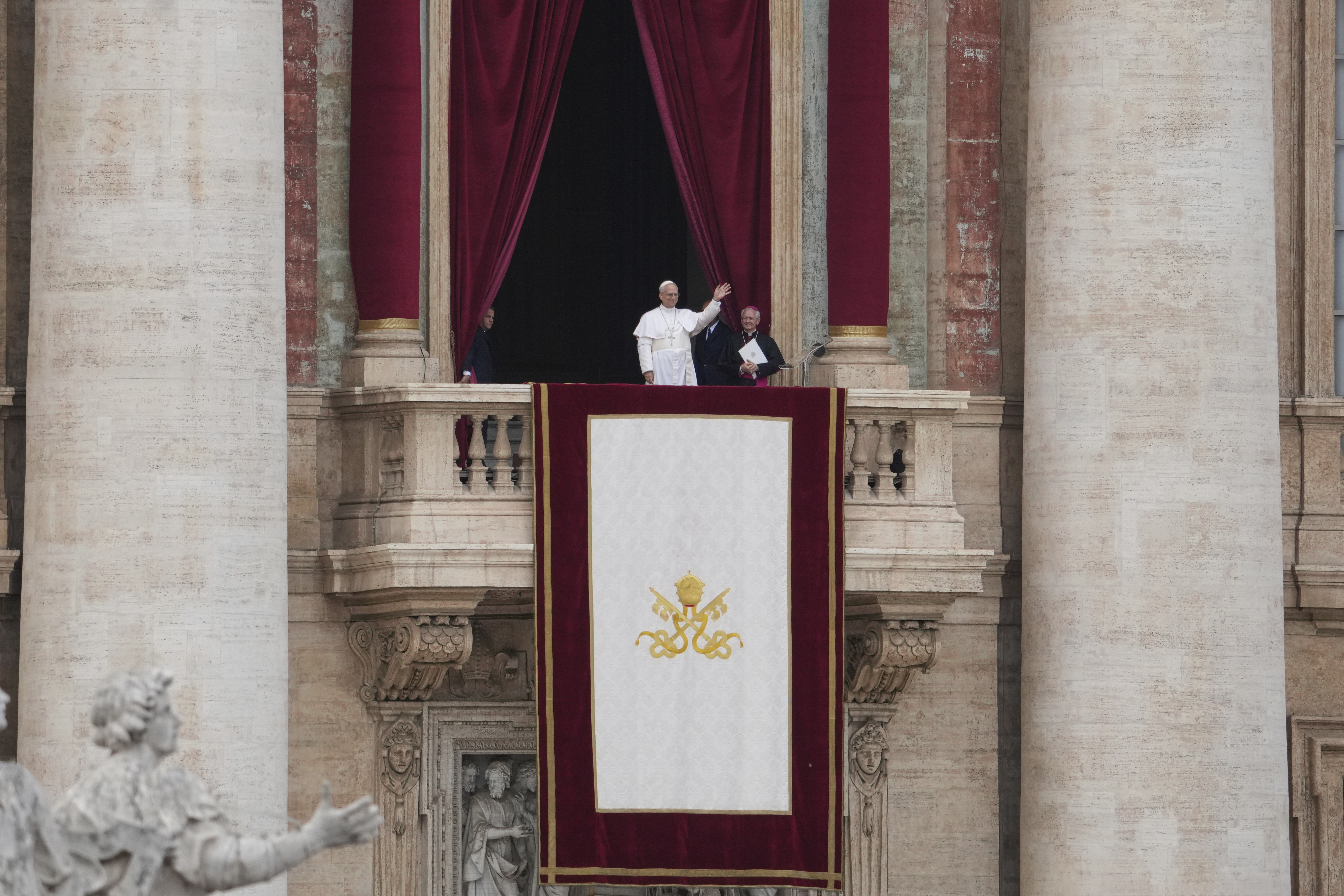 Pope Leo XIV appears at the central balcony of St. Peter's Basilica for his first Sunday blessing after his election, in St. Peter¥s Square at the Vatican, Sunday May 11, 2025. (AP Photo/Alessandra Tarantino)