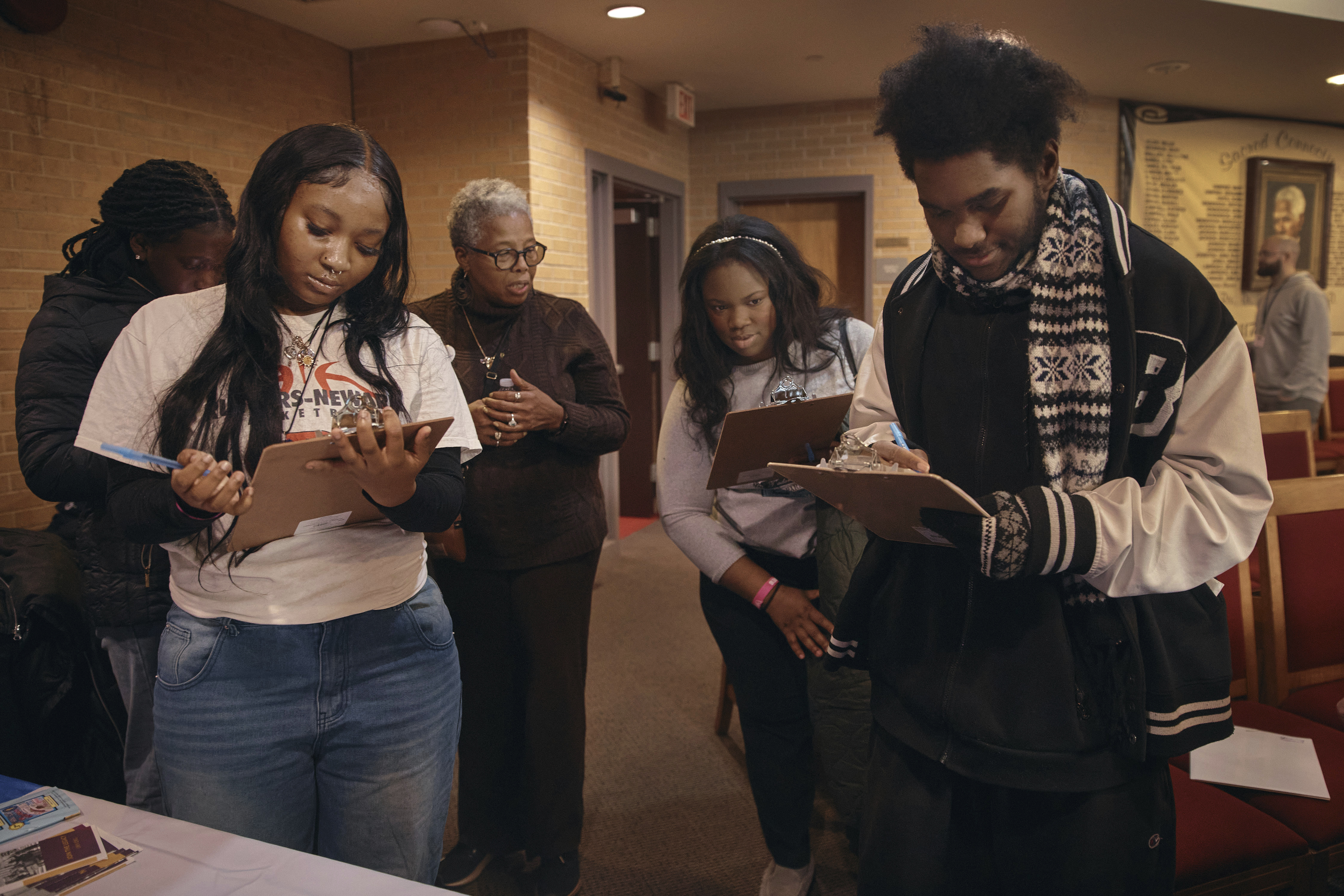 Students register to vote for school board elections during a Town Hall at the Bethany Baptist Church, Saturday, Feb. 1, 2025, in Newark, N.J. (AP Photo/Andres Kudacki)