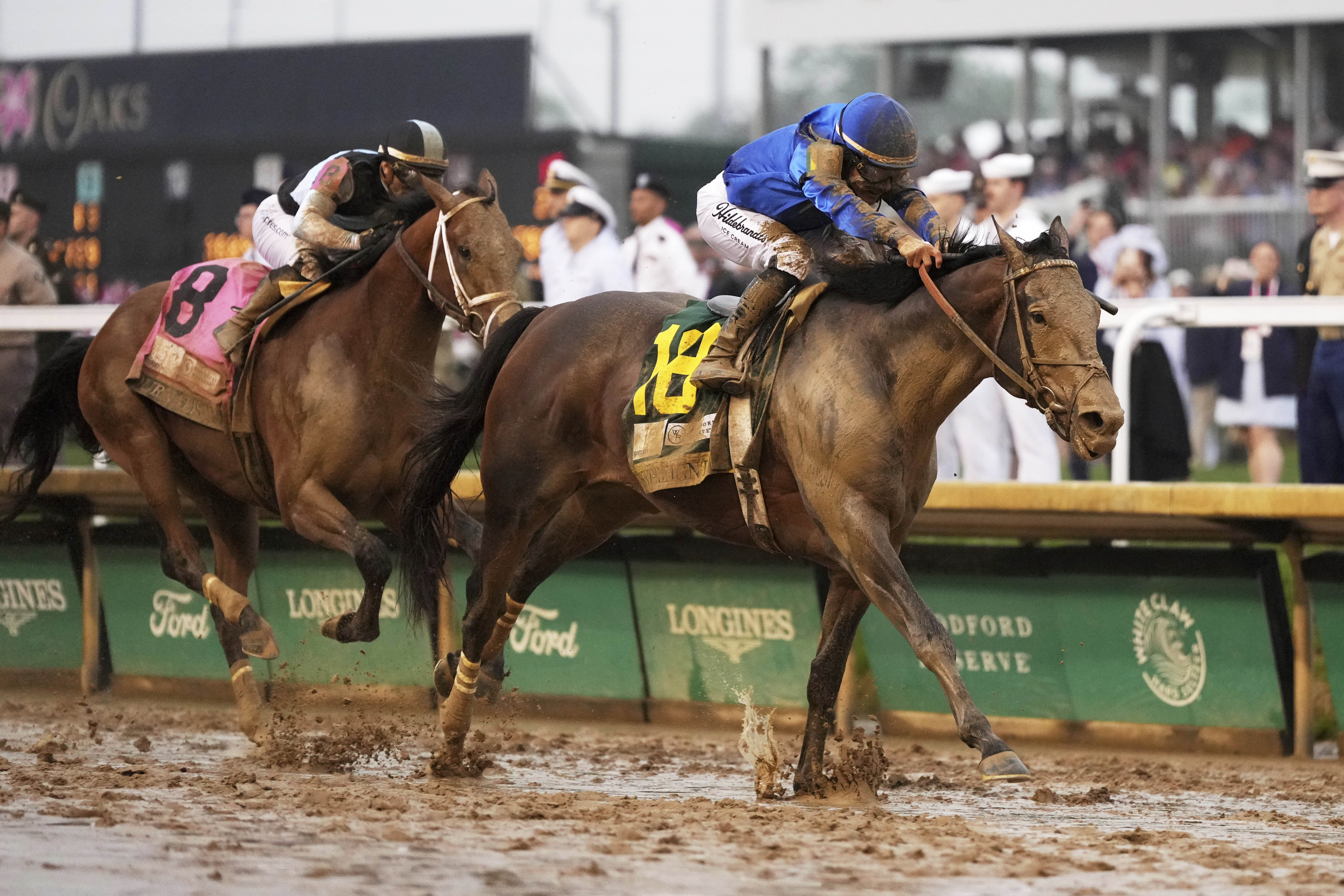 Sovereignty, right, ridden by Junior Alvarado, crosses the finish line to win the 151st running of the Kentucky Derby horse race followed by Journalism, ridden by Umberto Rispoli, at Churchill Downs Saturday, May 3, 2025, in Louisville, Ky. (AP Photo/Jeff Roberson)