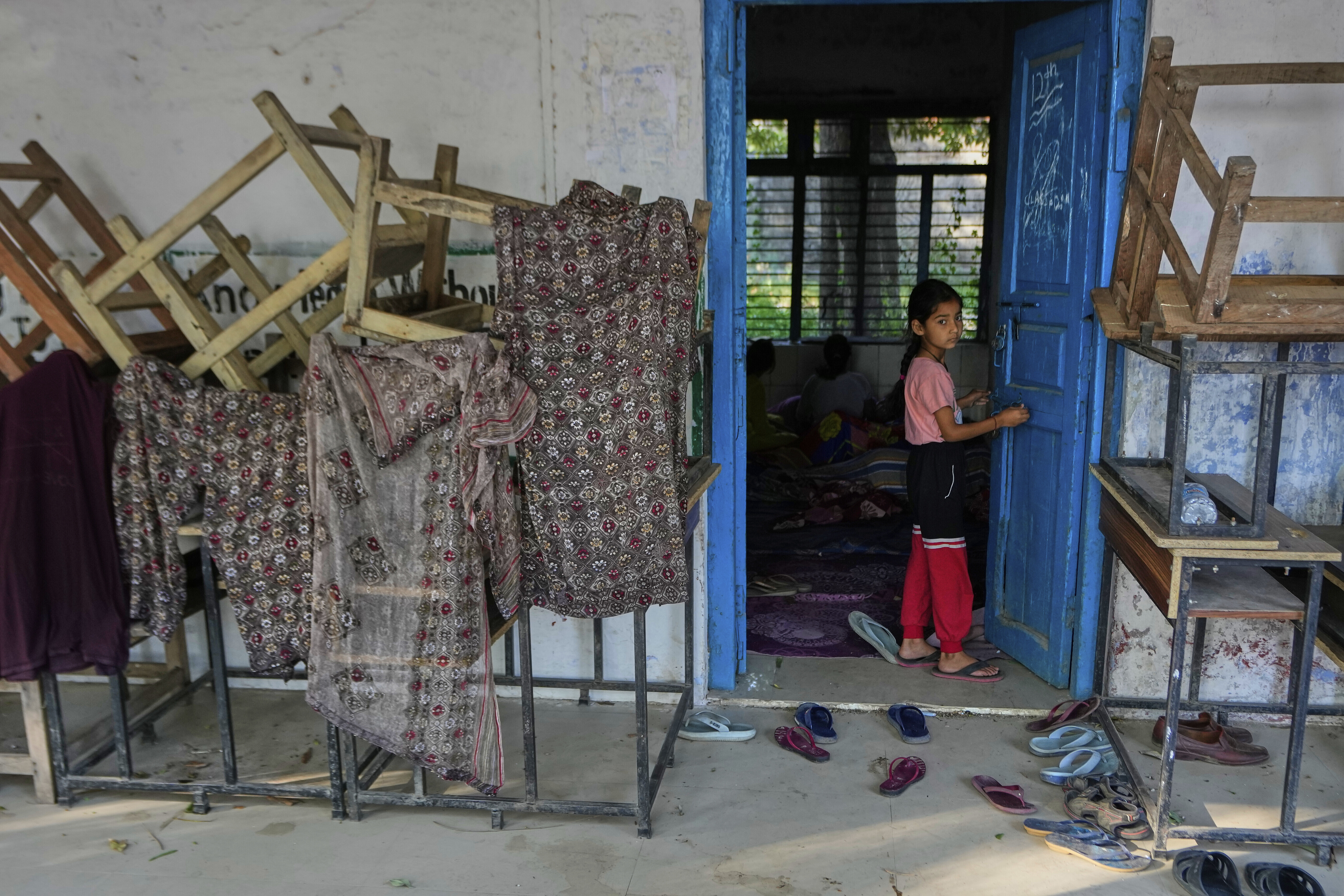 A girl evacuated from her village along the India Pakistan border takes refuge in a makeshift center in a school at RS Pura, along the International Border, India, Monday, May 12, 2025. (AP Photo/Channi Anand)