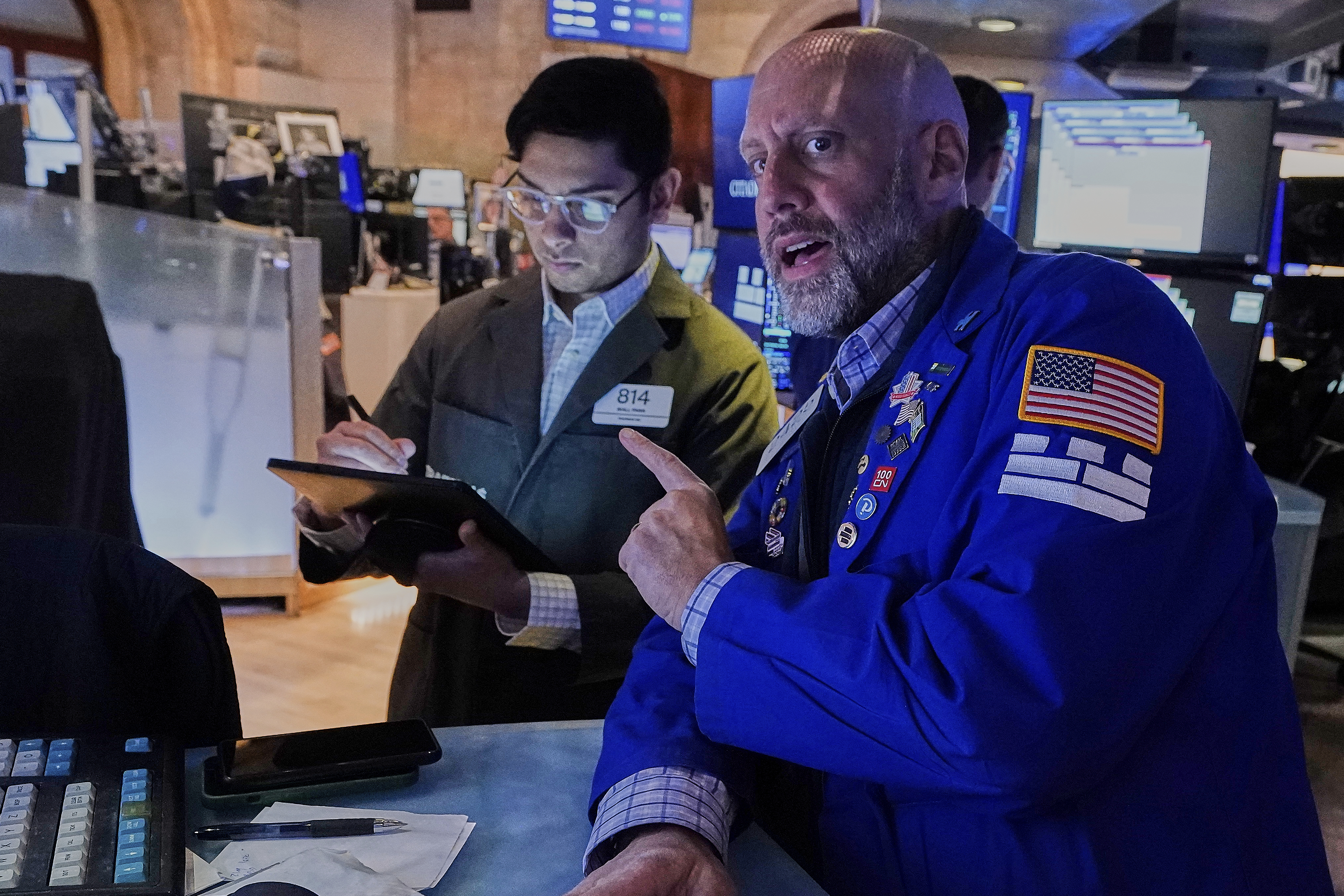Trader Niall Pawa, left, and specialist Meric Greenbaum work on the floor of the New York Stock Exchange, Monday, May 12, 2025. (AP Photo/Richard Drew)