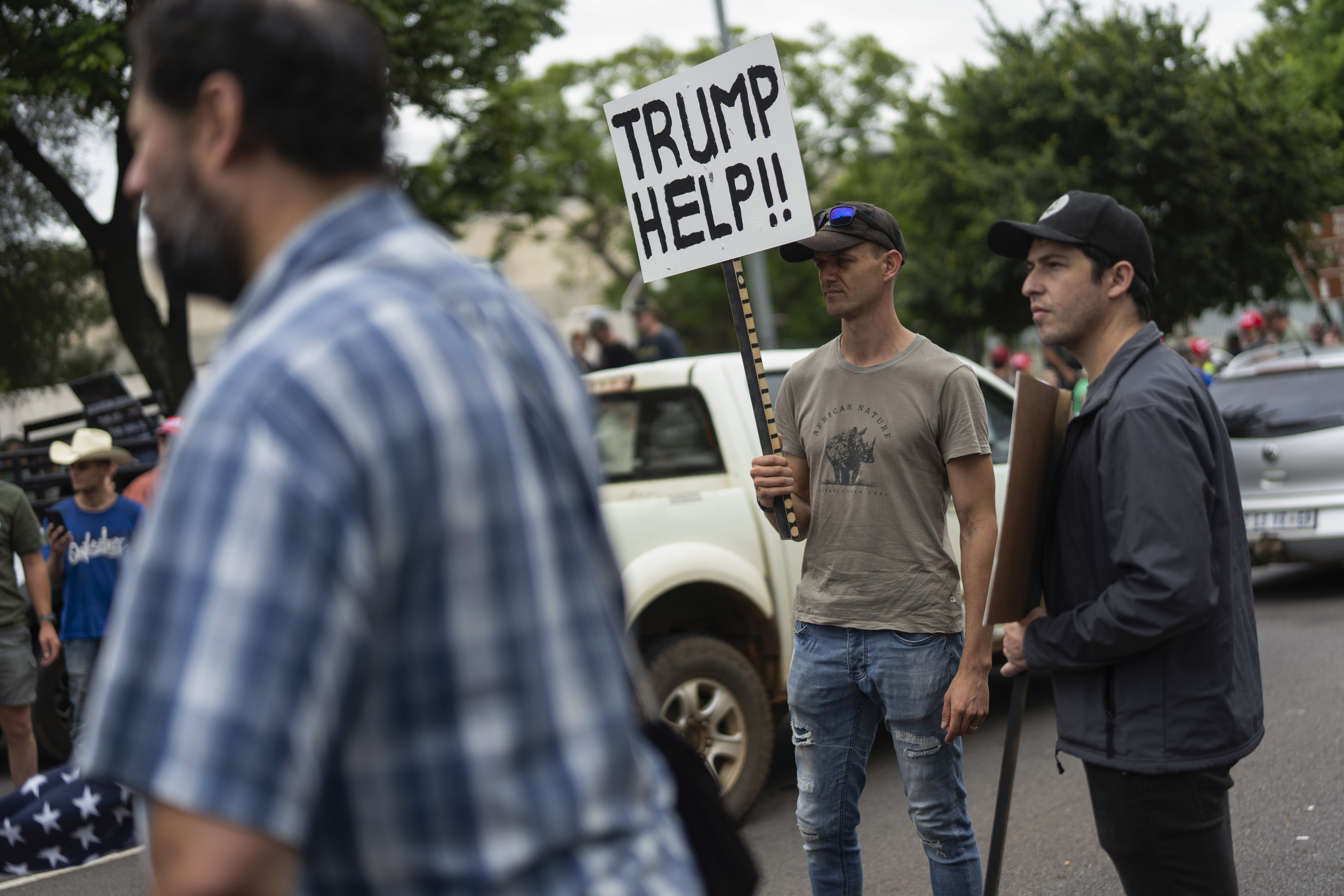 FILE - White South Africans demonstrate in support of U.S. President Donald Trump in front of the U.S. embassy in Pretoria, South Africa, Saturday, Feb. 15, 2025. (AP Photo/Jerome Delay, File)