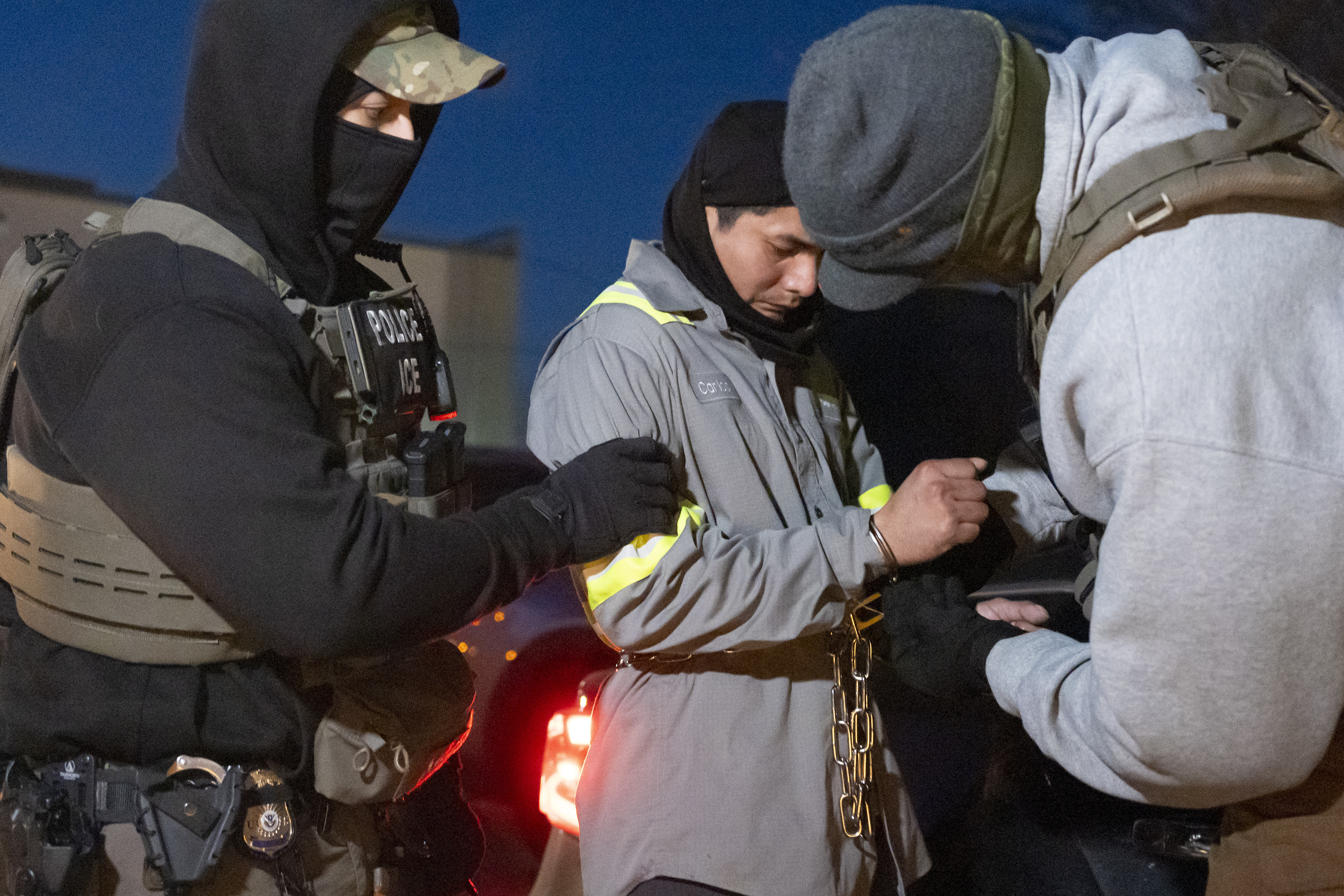 FILE - U.S. Immigration and Customs Enforcement officers use a chain to more comfortably restrain a detained person using handcuffs positioned in front, Jan. 27, 2025, in Silver Spring, Md. (AP Photo/Alex Brandon, file)