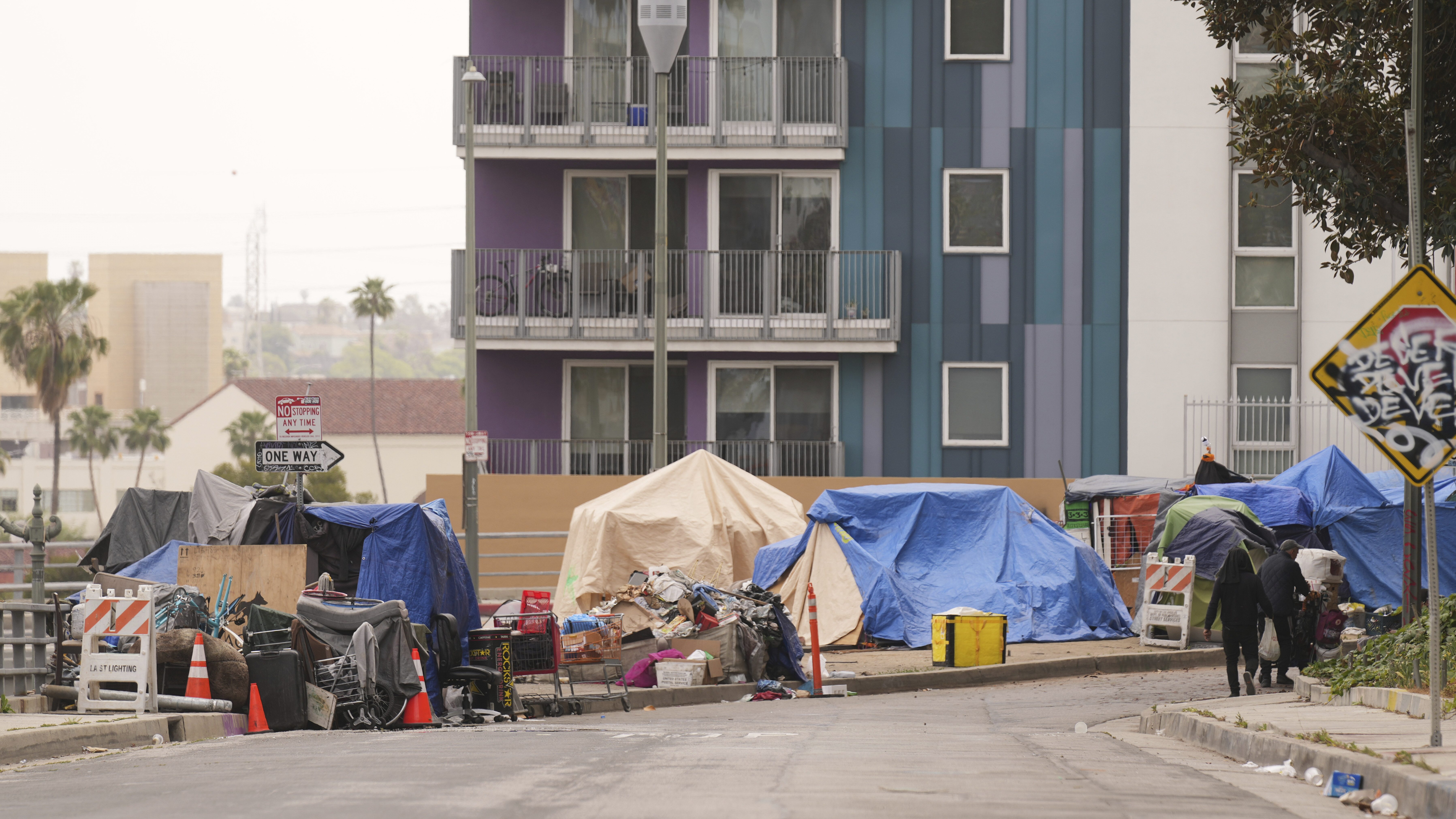 Tents are set up along a freeway in a homeless encampment Monday, May 12, 2025, in Los Angeles. (AP Photo/Damian Dovarganes)