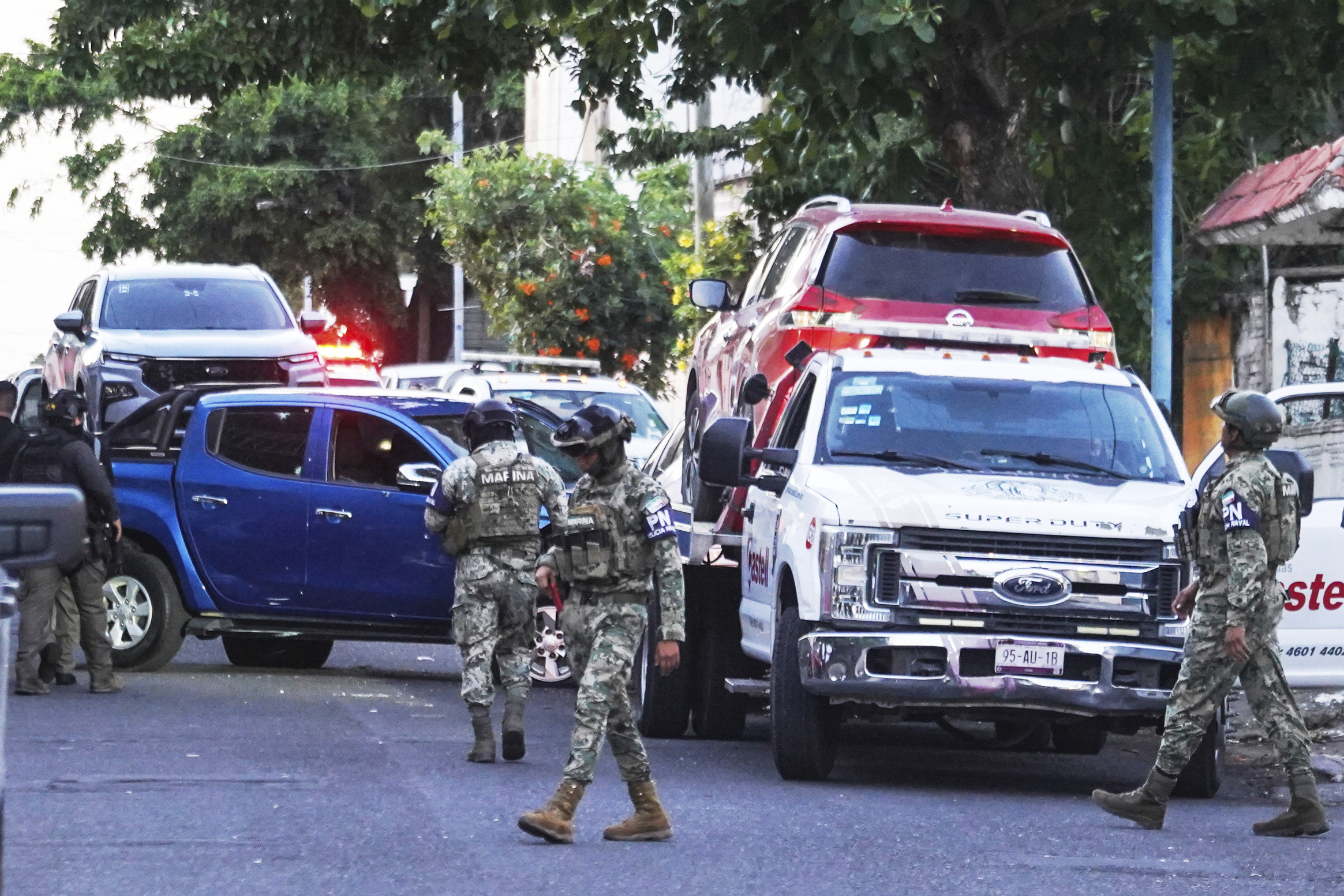 Navy officers stand guard near a vehicle involved in a shootout in Veracruz, Mexico, Monday, May 12, 2025. (AP Photo/Victoria Razo)