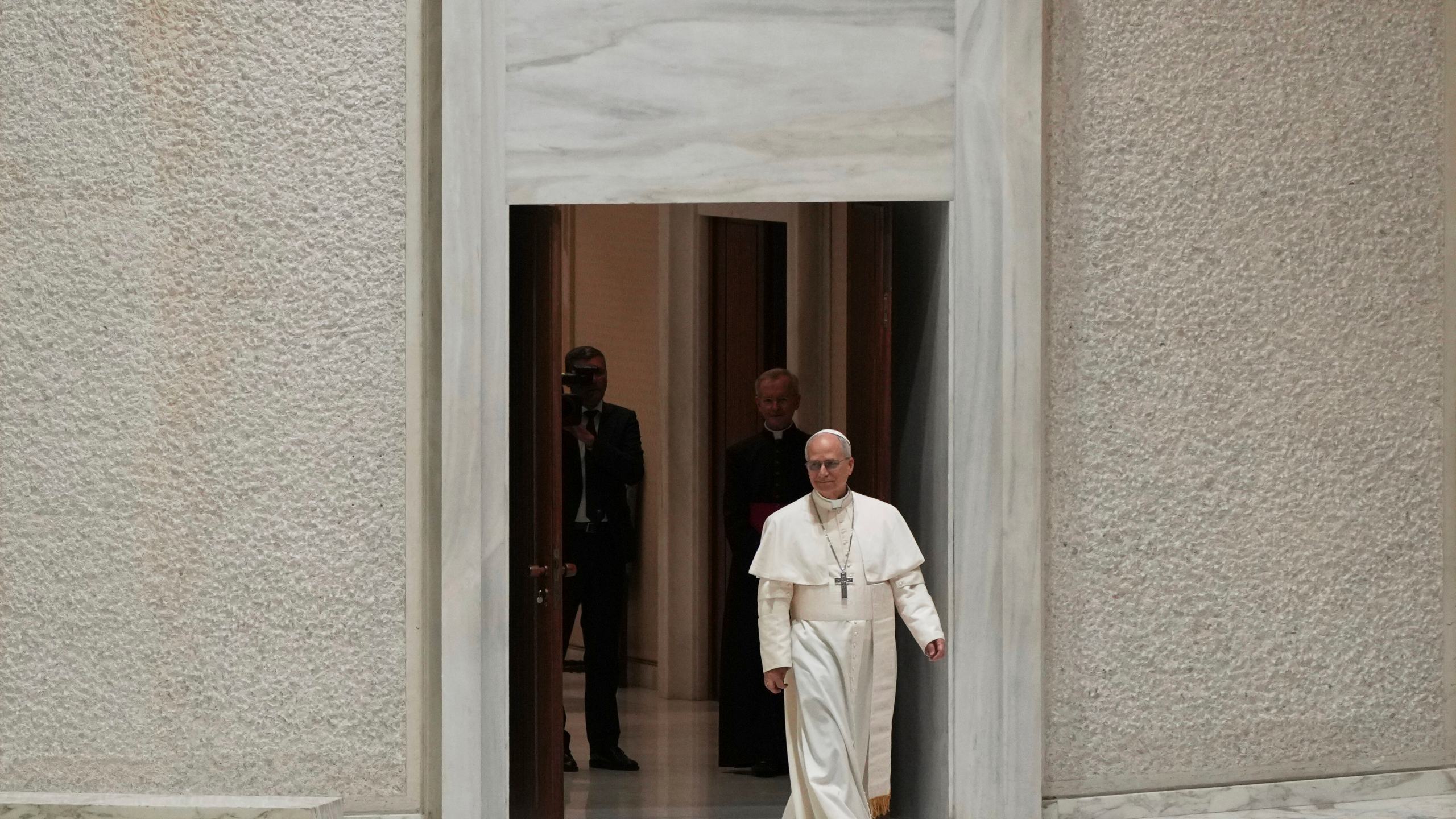 Pope Leo XIV arrives to meet with members of the international media in the Paul VI Hall at the Vatican, Monday, May 12, 2025. (AP Photo/Domenico Stinellis)