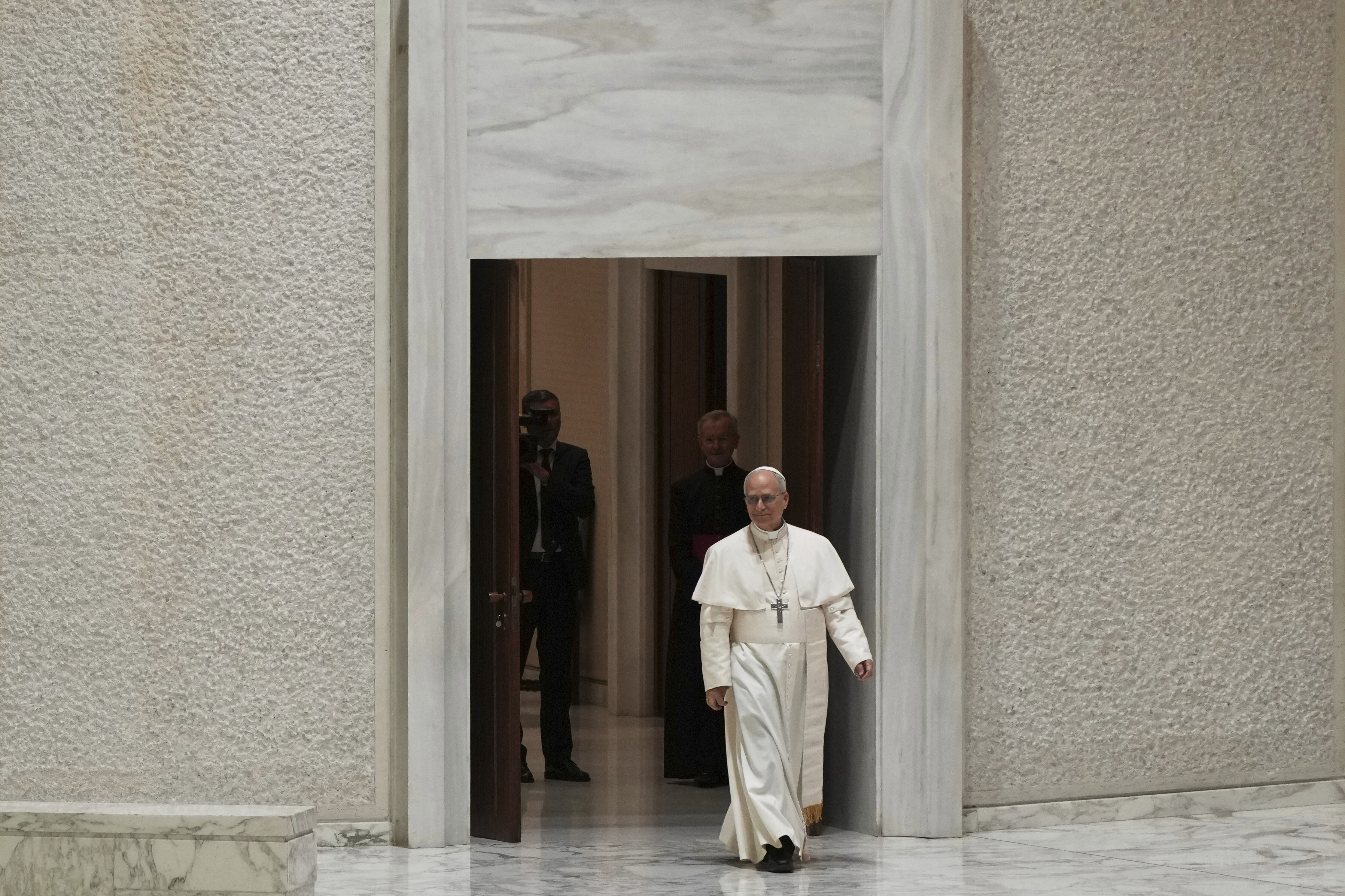 Pope Leo XIV arrives to meet with members of the international media in the Paul VI Hall at the Vatican, Monday, May 12, 2025. (AP Photo/Domenico Stinellis)