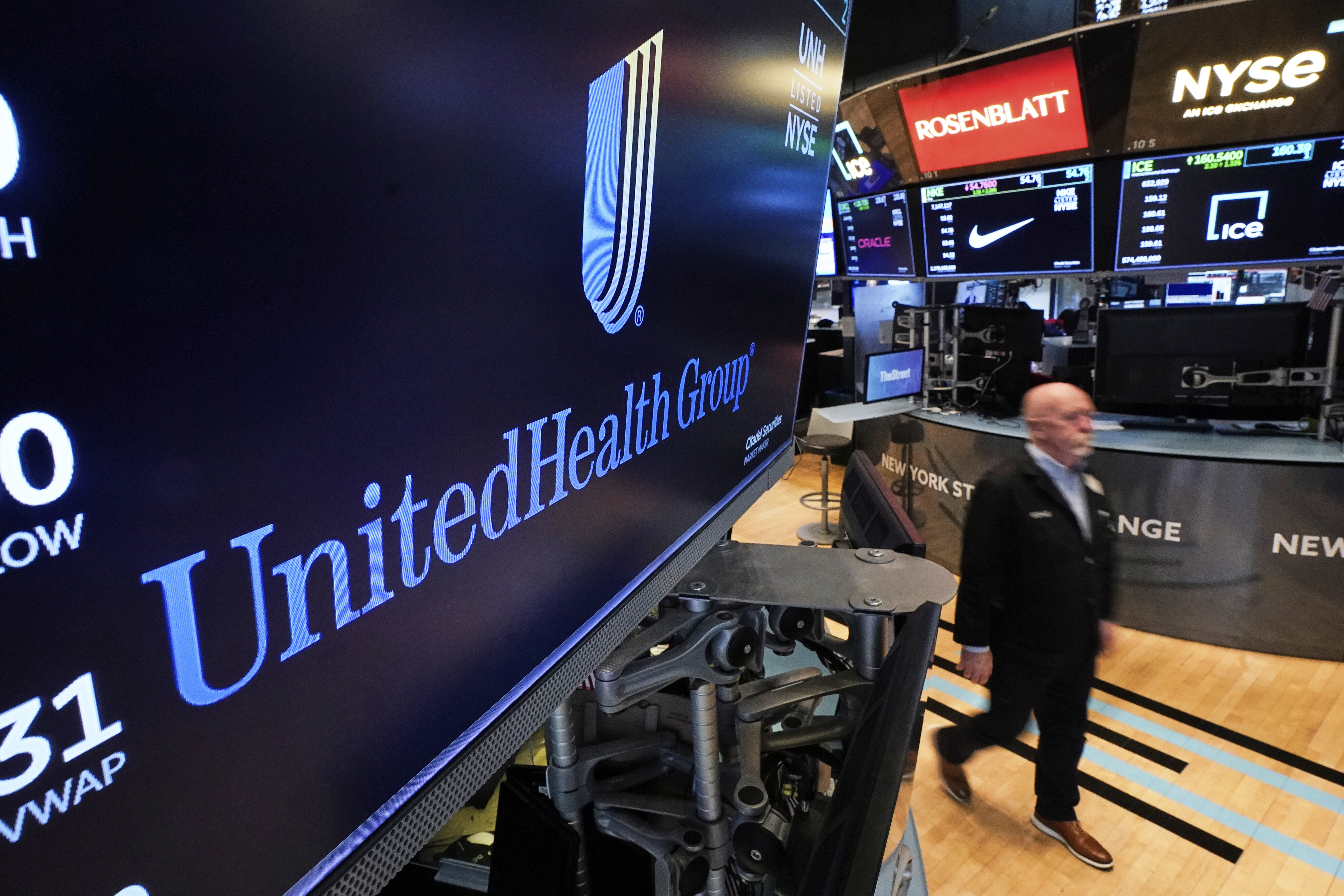The logo for UnitedHealth Group appears above a trading post on the floor of the New York Stock Exchange, Thursday, April 17, 2025. (AP Photo/Richard Drew)