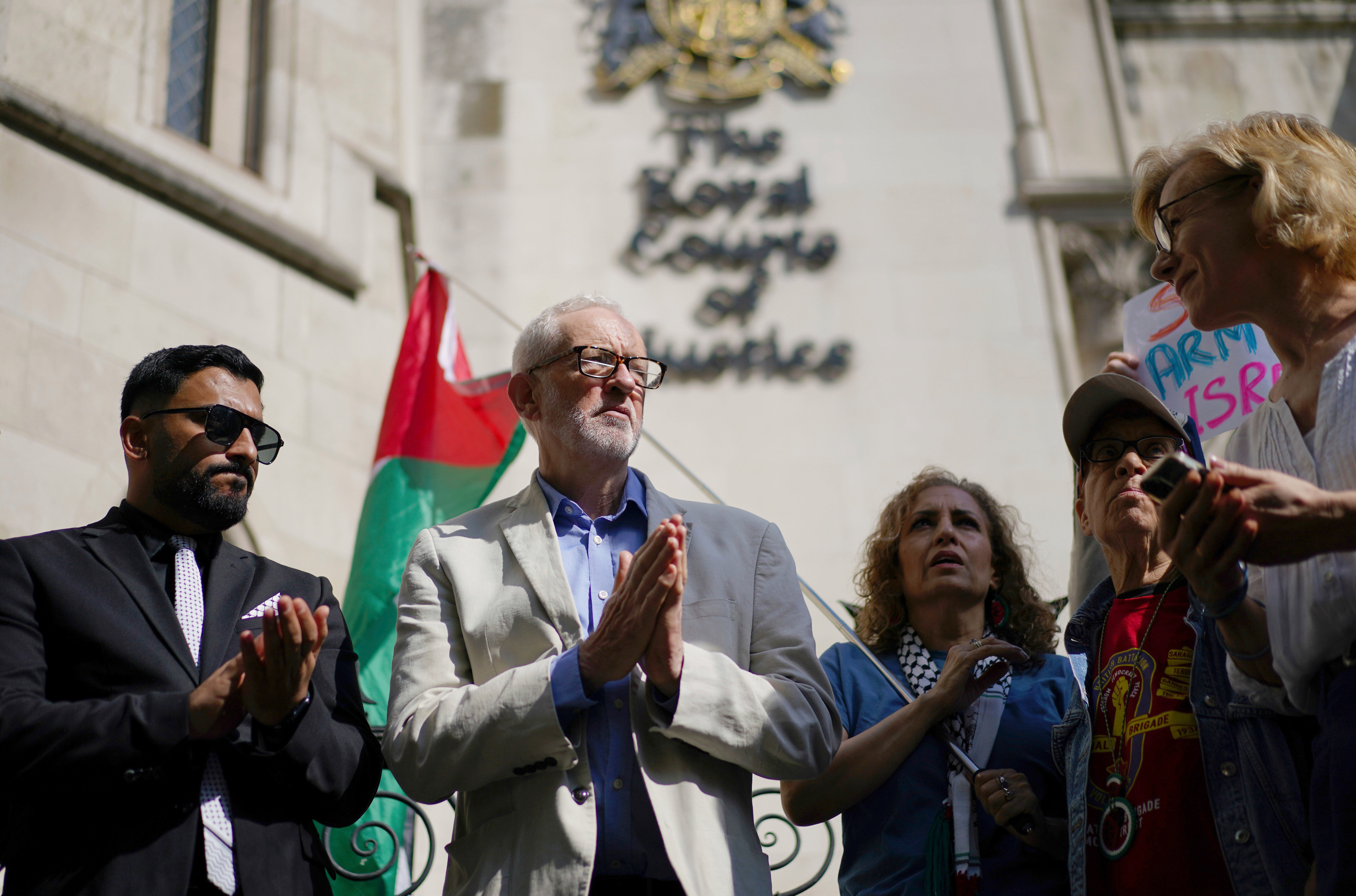 Britain's Member of Parliament Jeremy Corbyn, second left, joins demonstrators outside the Royal Courts of Justice, central London, where Palestinian human rights organization Al-Haq is taking legal action against the Department for Business and Trade over several decisions, Tuesday, May 13, 2025. (Ben Whitley/PA via AP)