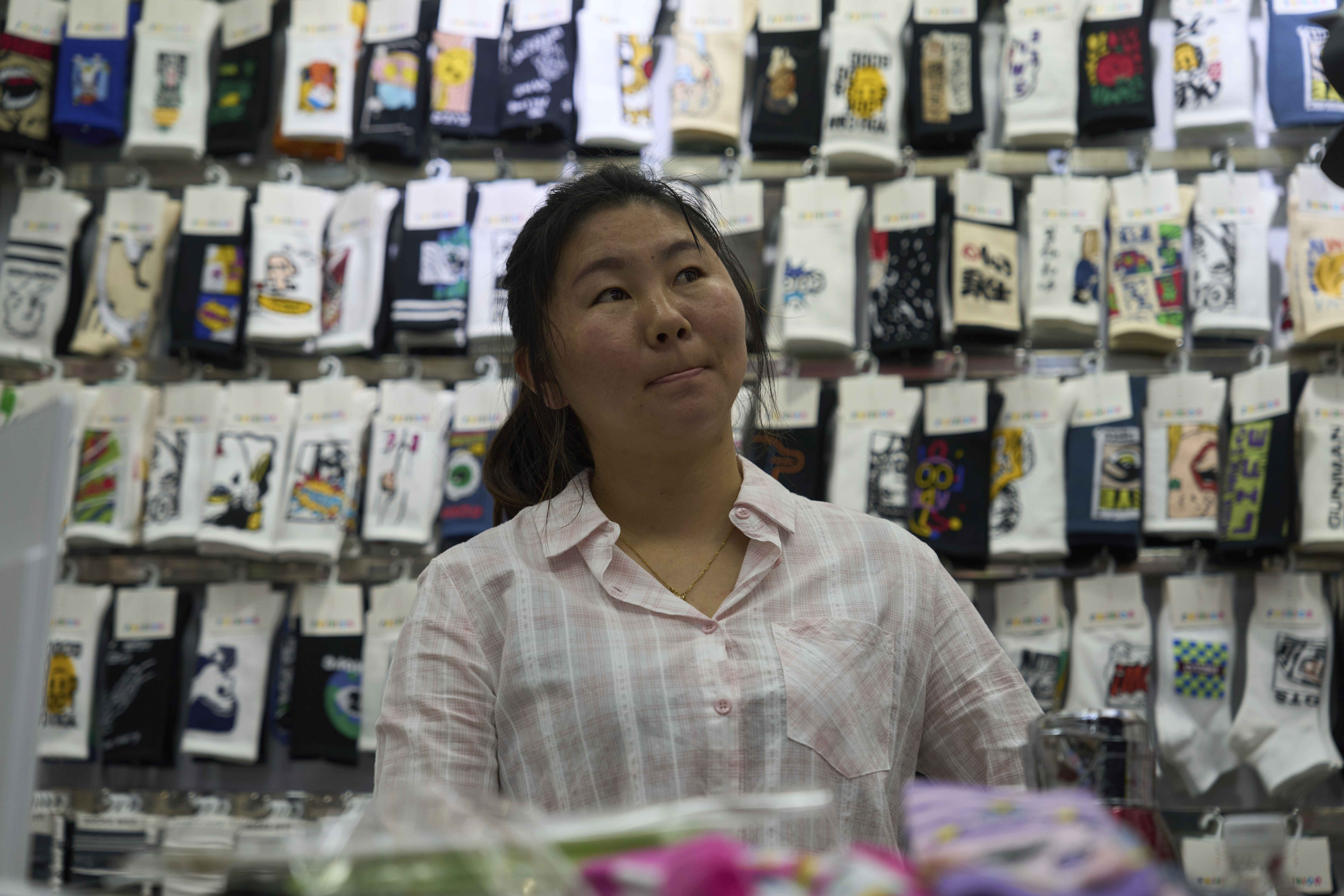 Wu Liying who runs the Xinyue Stockings Co. reacts at the Yiwu International Trade Market in Yiwu, eastern China's Zhejiang province on Thursday, April 10, 2025. (AP Photo/Ng Han Guan)