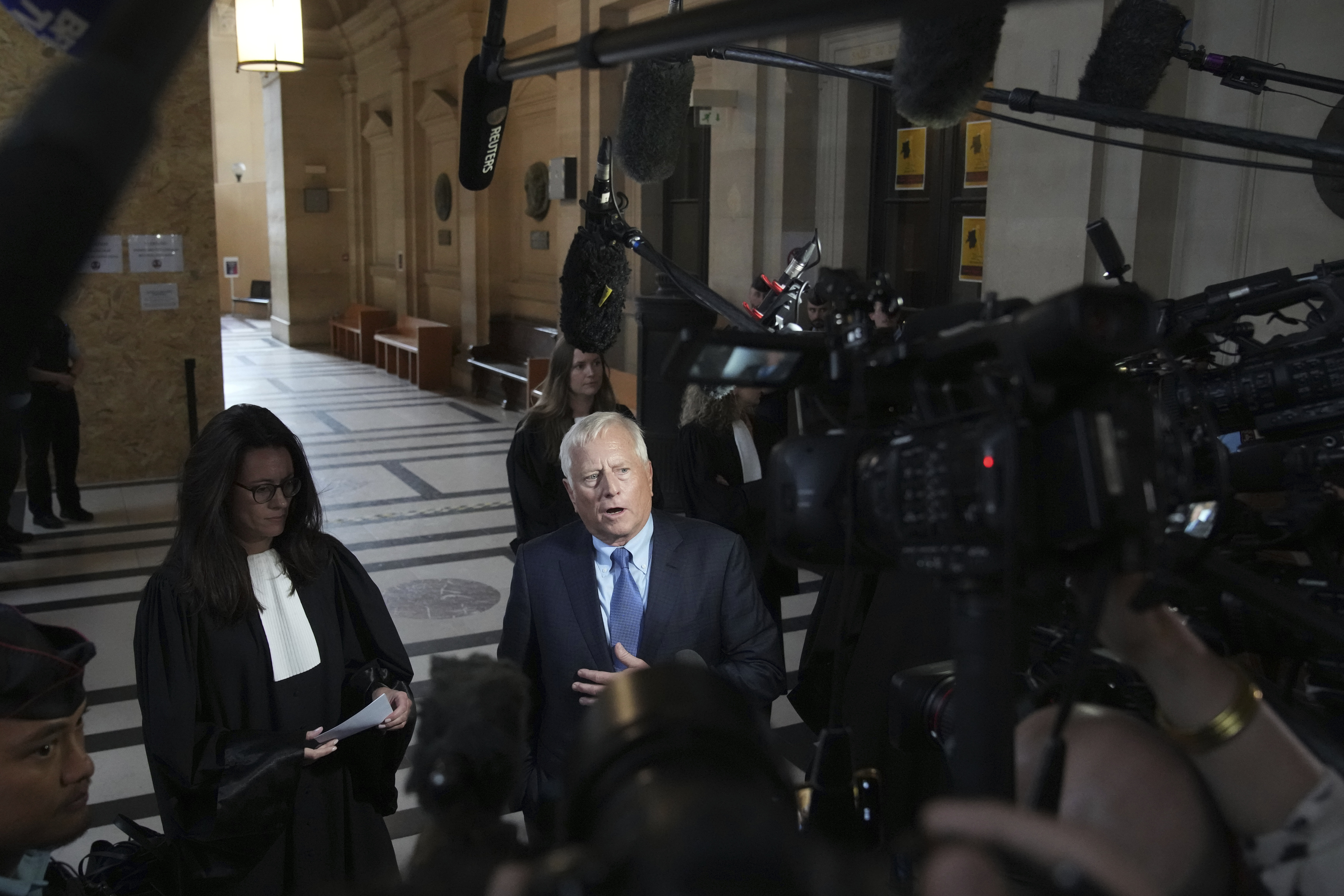 Michael Rhodes, lawyer for Kim Kardashian, speaks with the media at the justice palace after the testimony of his client regarding a robbery of millions of dollars in jewels from her Paris hotel room in 2016, in Paris, Tuesday, May 13, 2025. (AP Photo/Christophe Ena)