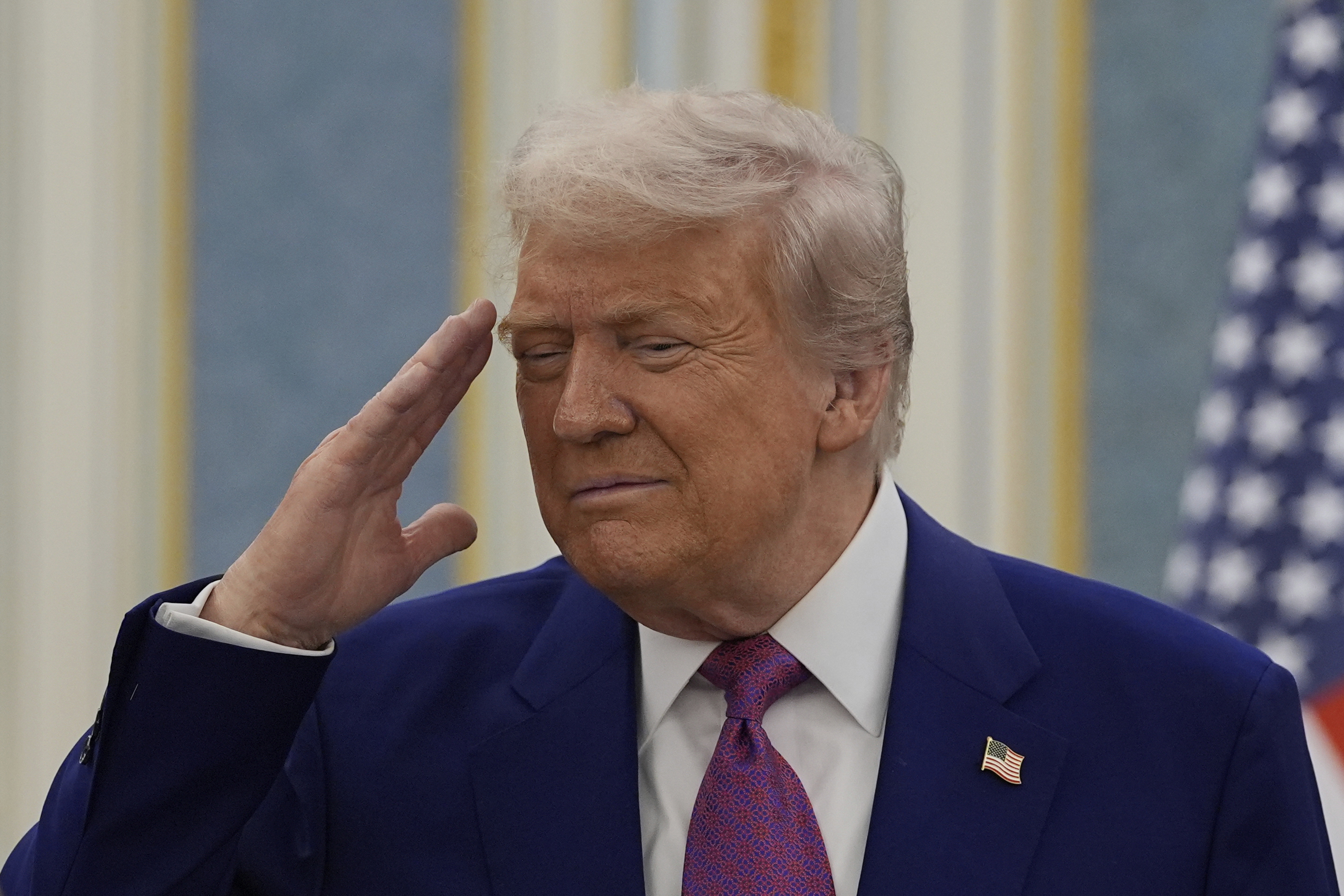 President Donald Trump salutes as he greets with Saudi Crown Prince Mohammed bin Salman delegations at the Royal Palace in Riyadh, Saudi Arabia, Tuesday, May 13, 2025. (AP Photo/Alex Brandon)