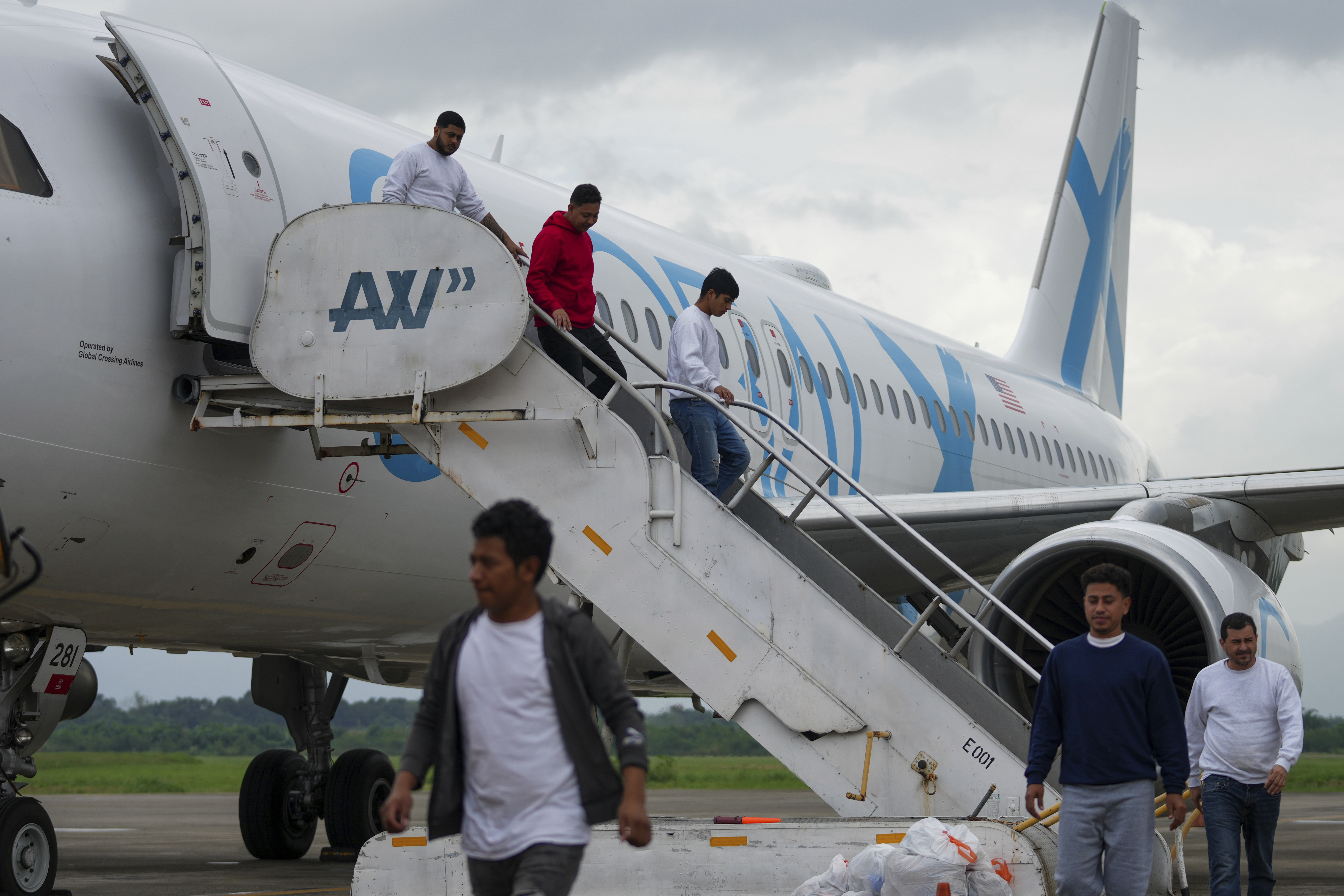 FILE - Honduras migrants who were deported from the U.S. deplane at Ramon Villeda Morales Airport, in San Pedro Sula, Honduras, Dec. 4, 2024. (AP Photo/Moises Castillo, File)
