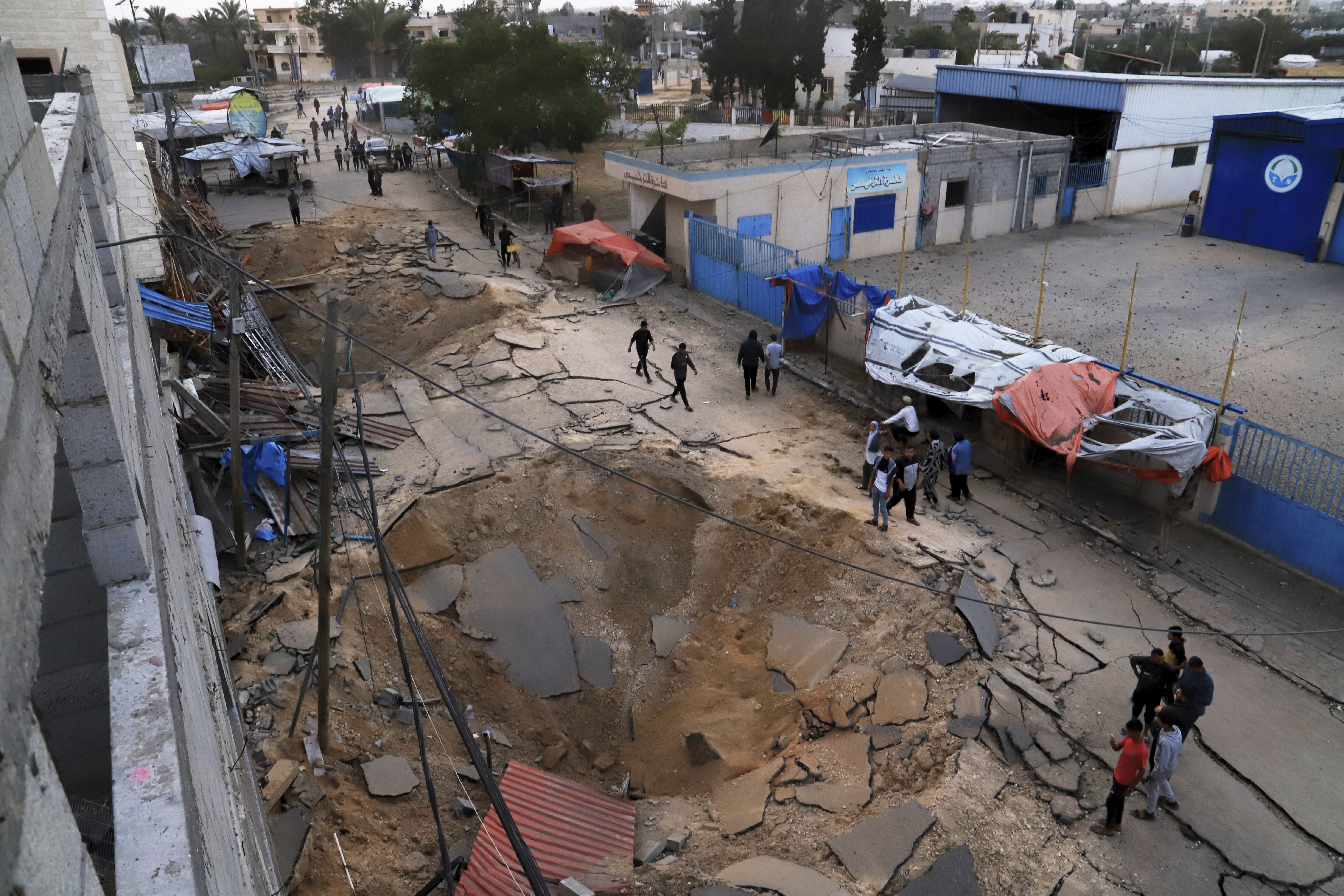 Palestinians inspect the site of an Israeli army airstrike on the European hospital in Khan Younis, Gaza Strip, Tuesday, May 13, 2025. The Israeli military said it had carried out a strike targeting what it said was a Hamas "command and control center" located beneath the hospital. (AP Photo/Mariam Dagga)