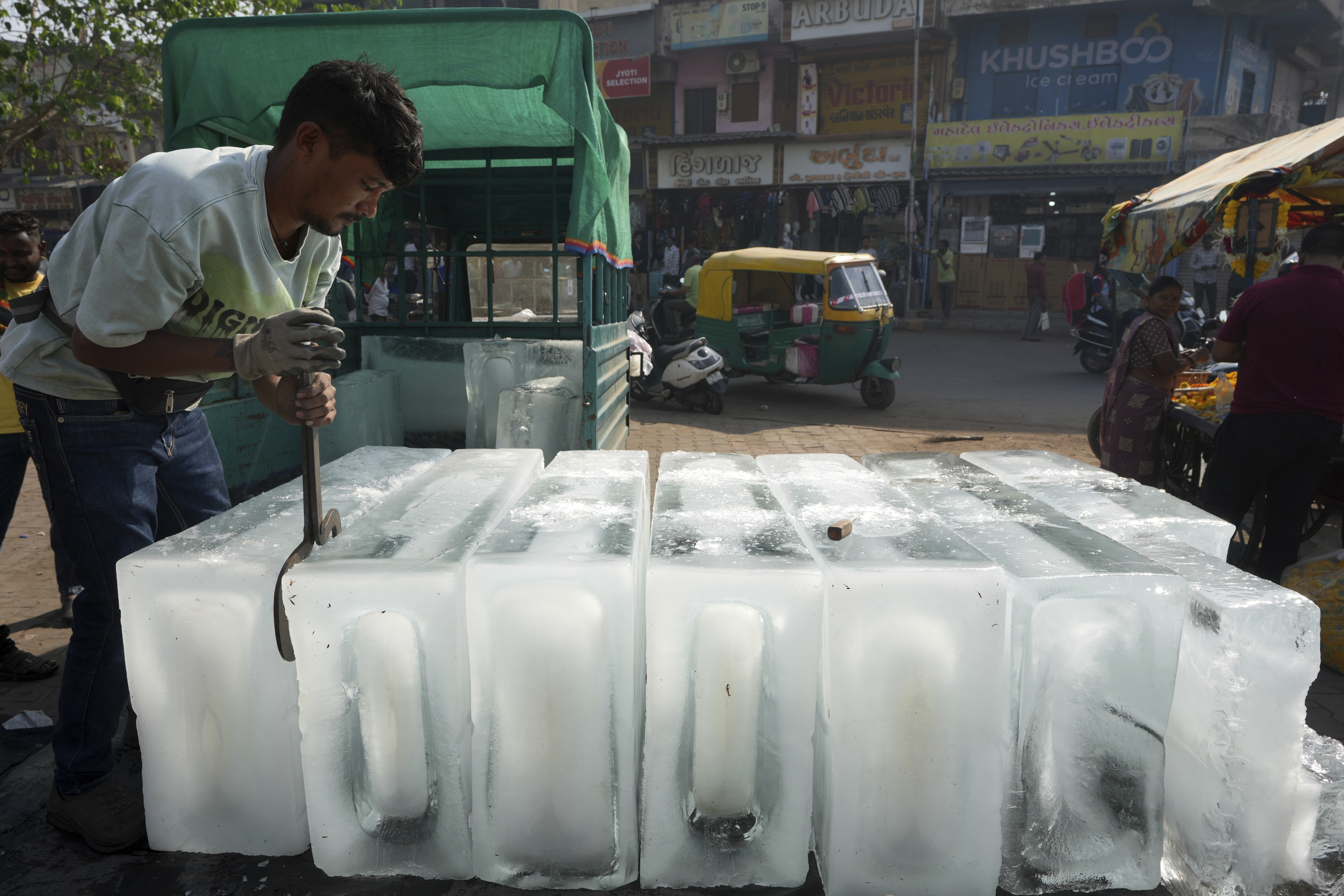 A man arranges ice blocks to sell at his stall in Ahmedabad, India, Wednesday, April 2, 2025. (AP Photo/Ajit Solanki)
