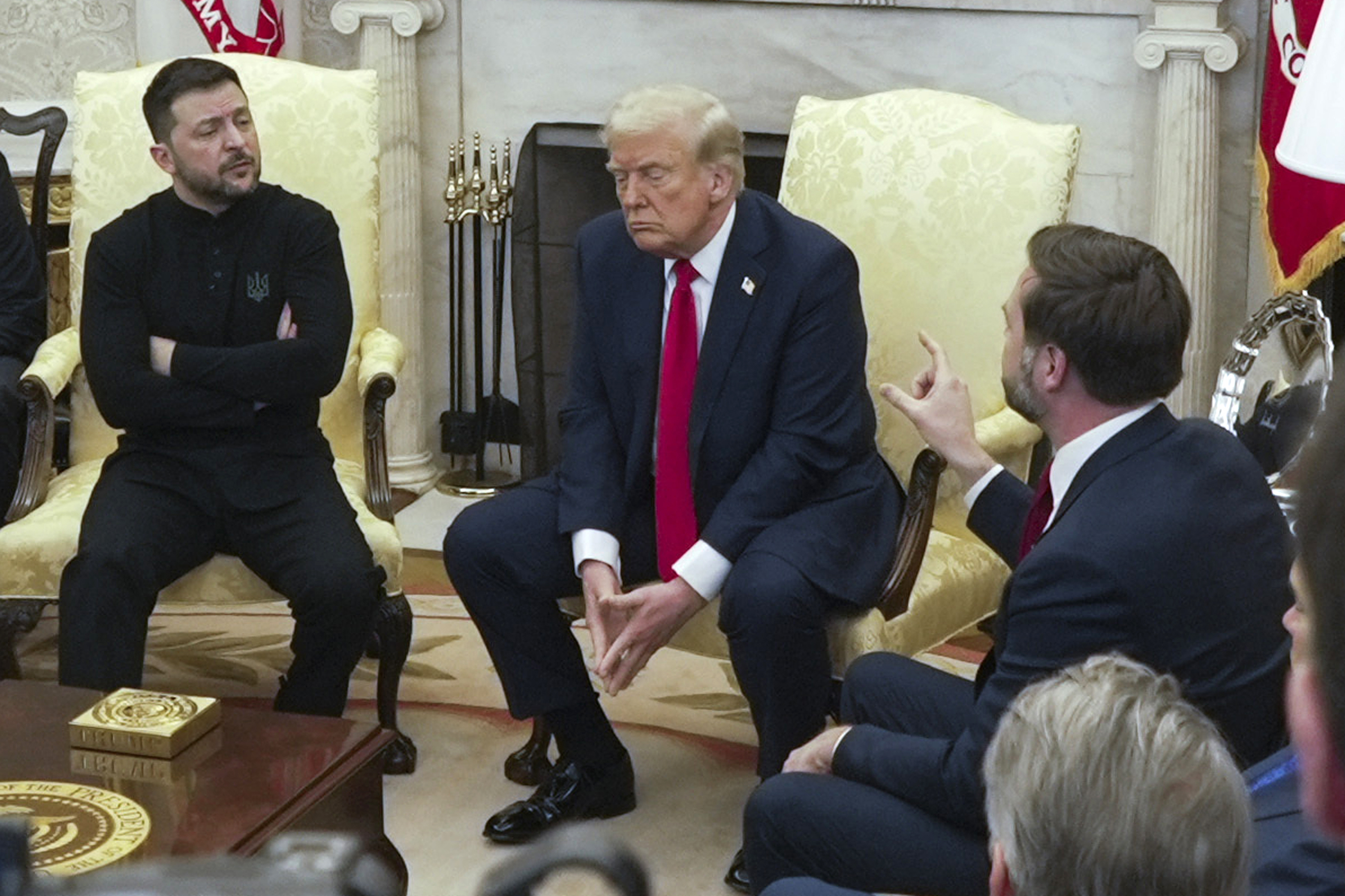 FILE - Vice President JD Vance, right, speaks with Ukrainian President Volodymyr Zelenskyy, left, as President Donald Trump listens in the Oval Office at the White House, Feb. 28, 2025, in Washington. (AP Photo/ Mystyslav Chernov, File)