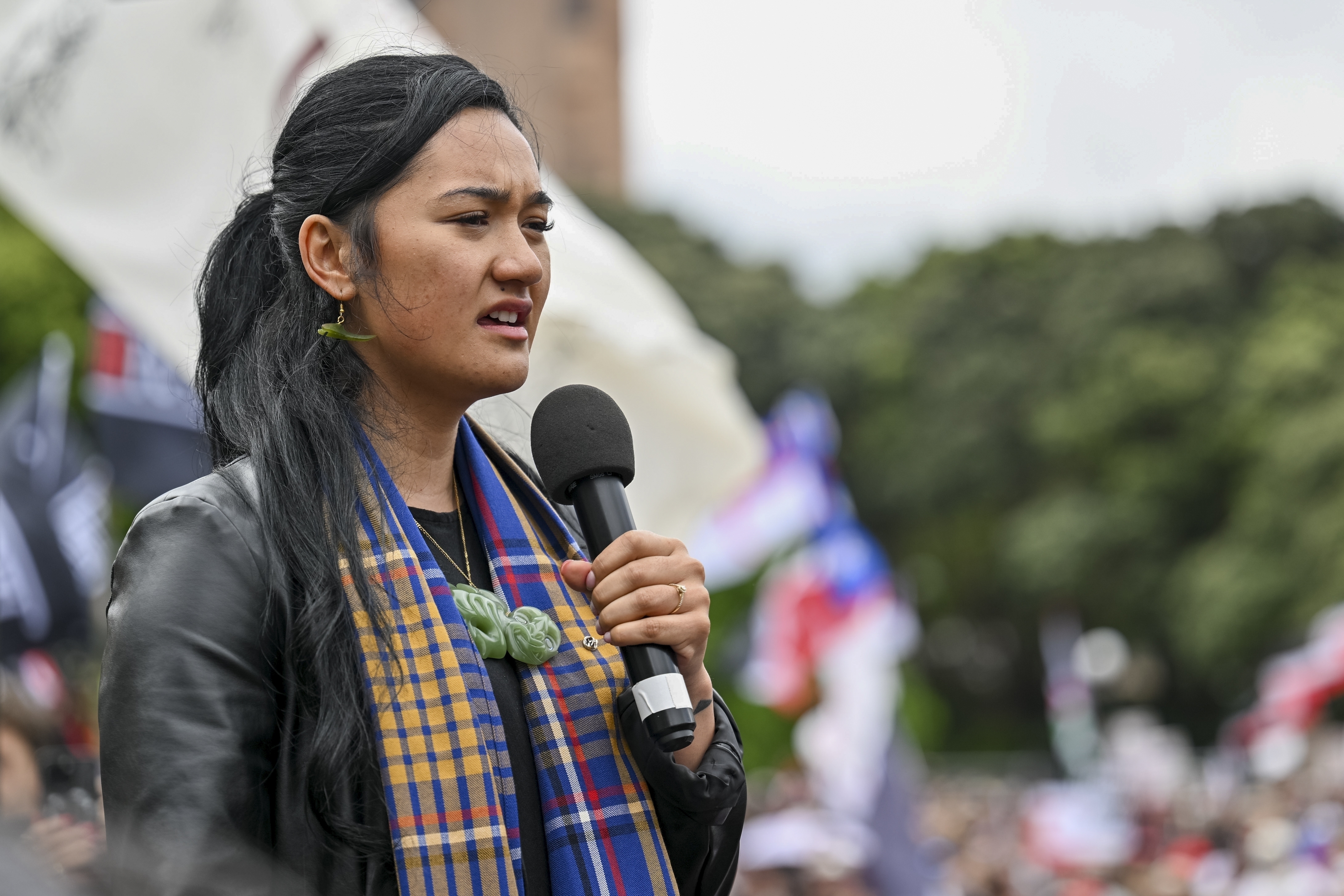 FILE -Hana-Rāwhiti Maipi-Clarke speaks to the thousands of people gathered outside New Zealand's parliament to protest a proposed law that would redefine the country's founding agreement between Indigenous Māori and the British Crown, in Wellington, Nov. 19, 2024. (AP Photo/Mark Tantrum, File)