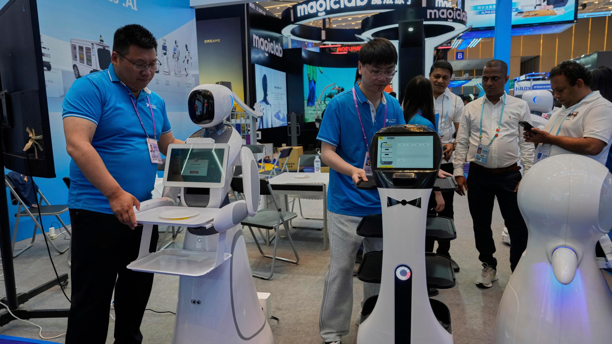 FILE - Vendors from AlphaRobotics.AI show off service robots at the 137th Canton Fair in Guangzhou in southern China's Guangdong province on April 16, 2025. (AP Photo/Ng Han Guan, File)