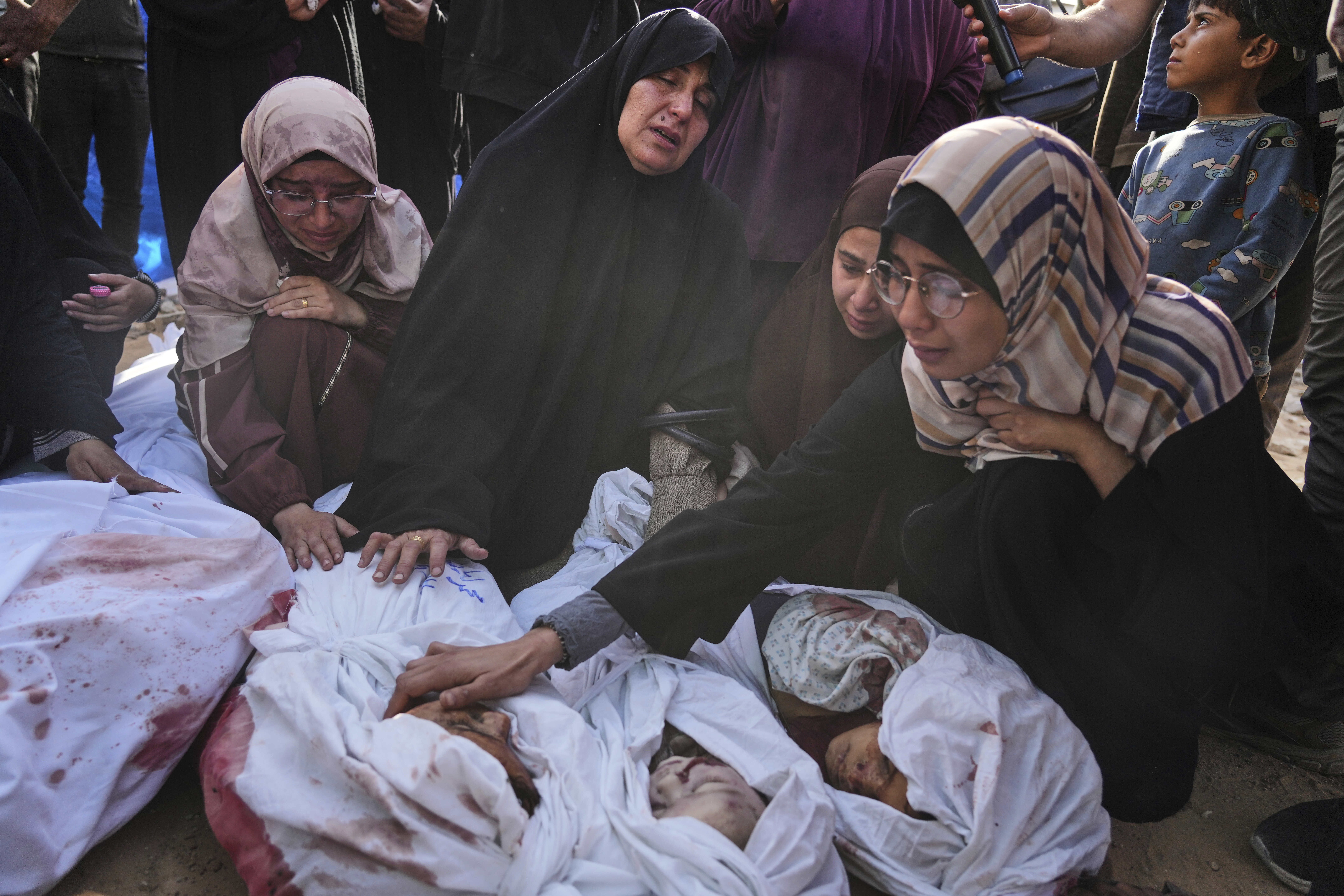 Palestinians mourn children from their families who were killed in Israeli airstrikes in Jabalia, in the northern Gaza Strip, on Wednesday, May 14, 2025. According to local hospitals, the strikes killed 48 people, including 22 children. (AP Photo/Jehad Alshrafi)