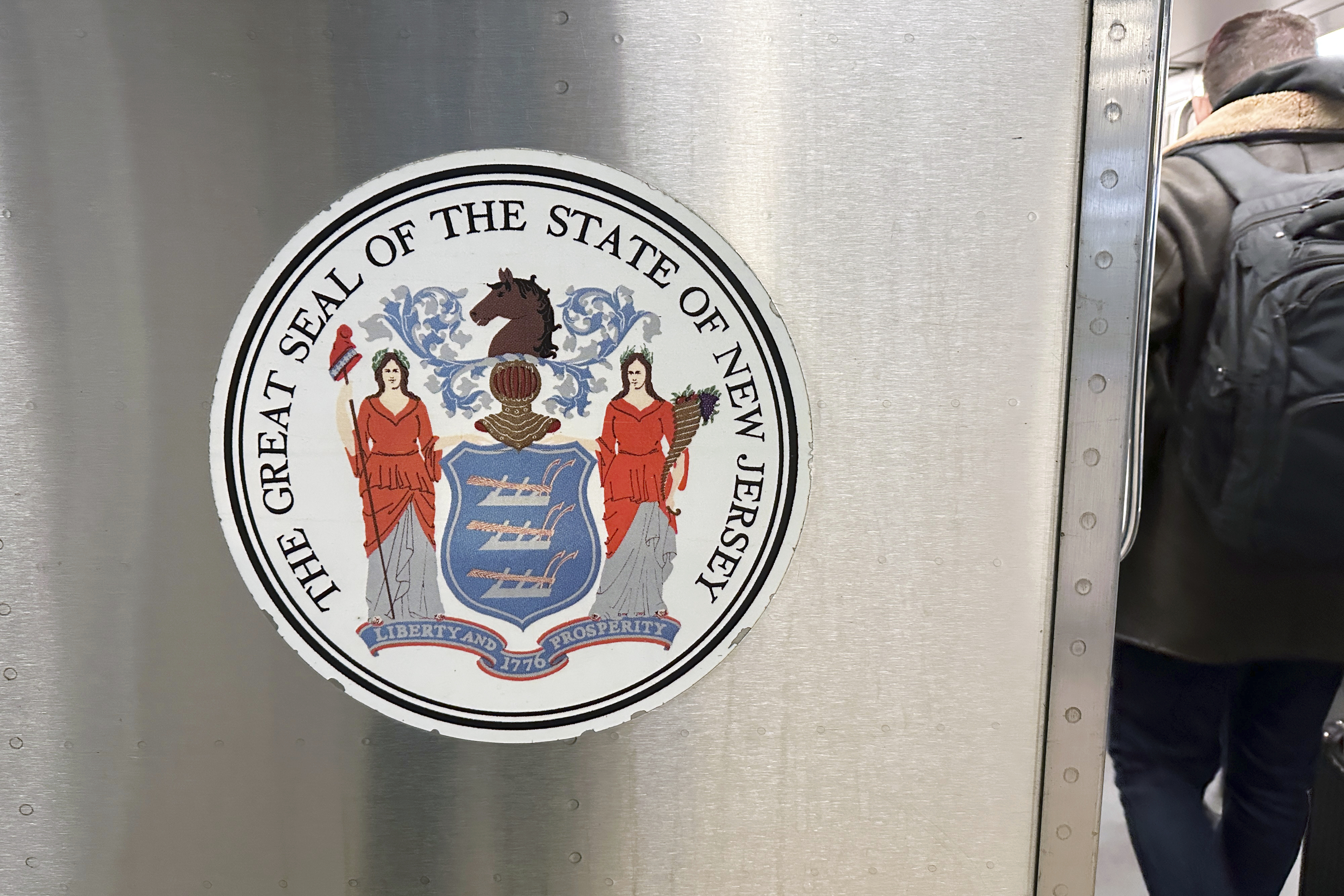 FILE - The seal of the state of New Jersey is on a New Jersey Transit train in Secaucus, New Jersey, on Saturday, December 23, 2023. (AP Photo/Ted Shaffrey, File)